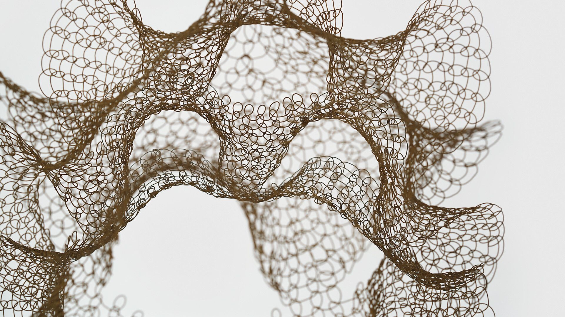A detail of a hanging steel wire sculpture by Ruth Asawa, titled, Untitled (S.786, Hanging Two-Sectioned, Open-Window Form), circa 1950 to 1959.