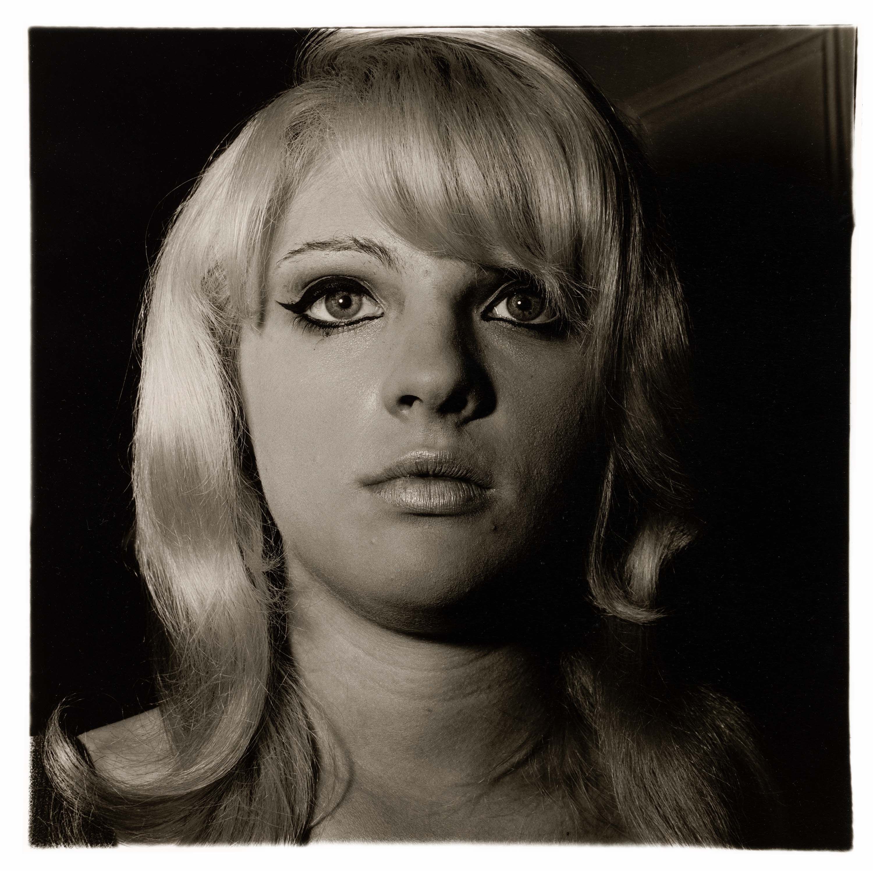 A photograph by Diane Arbus, titled Blonde girl with shiny lipstick, N.Y.C. 1967, dated 1967.