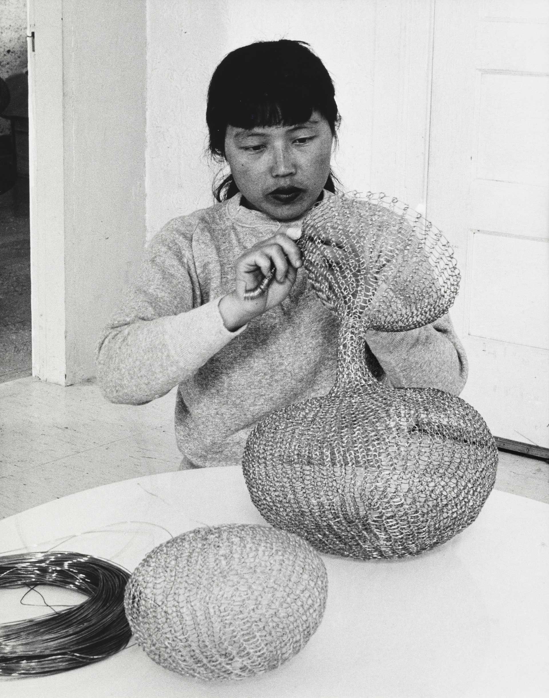 A photo by Imogen Cunningham titled Ruth Asawa at Work 3, dated 1956.