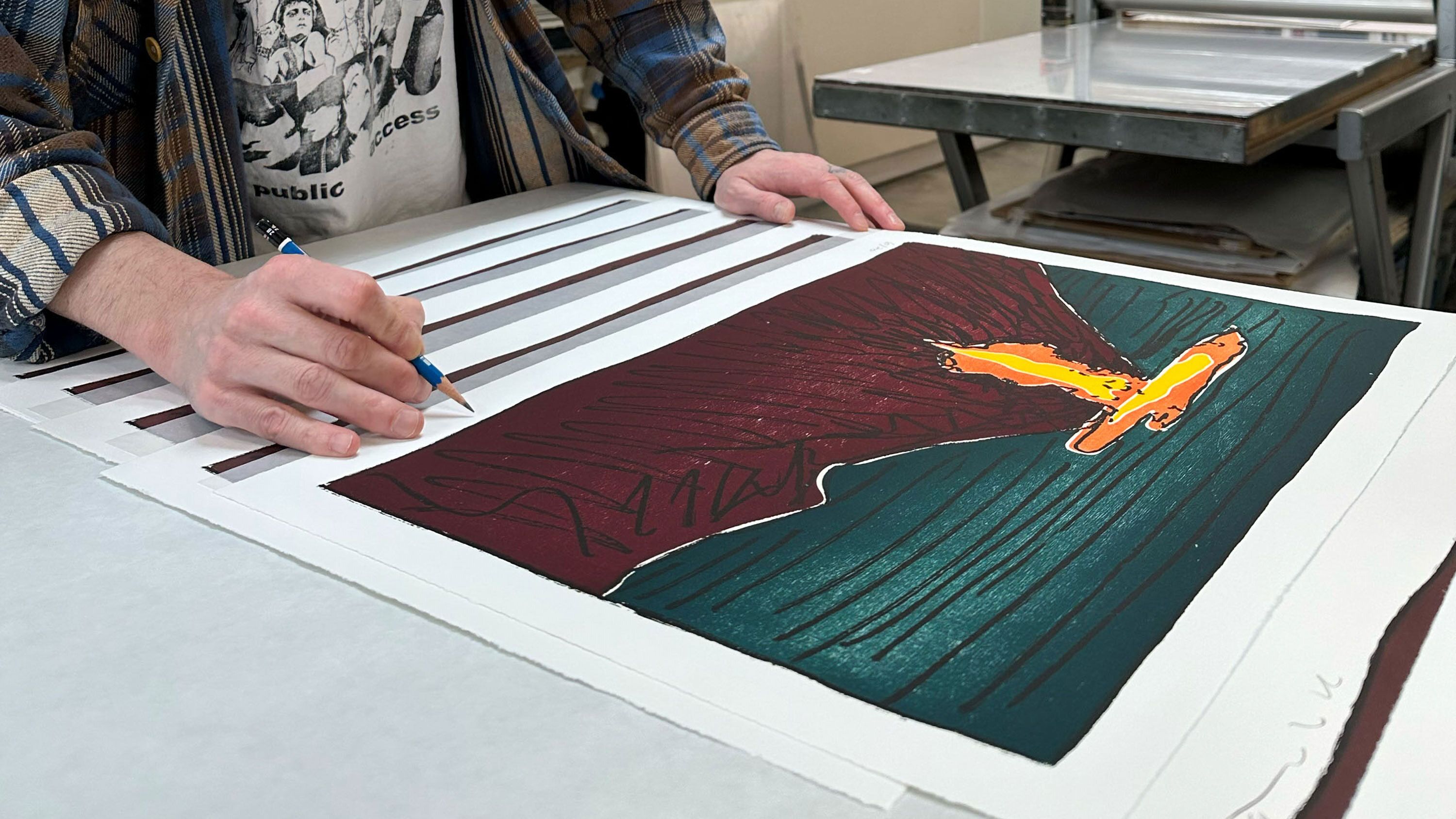 Lowman signs the edition at 10 Grand Press.