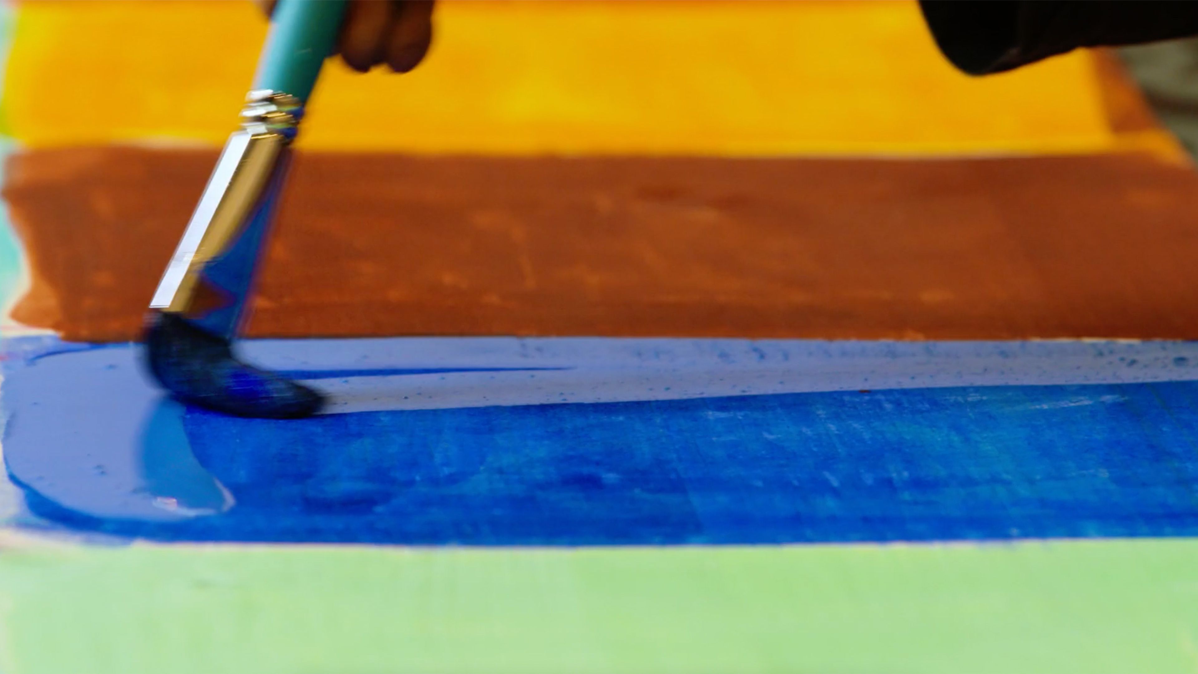 A detail from a video still depicts Stanley Whitney working on his prints, dated 2022