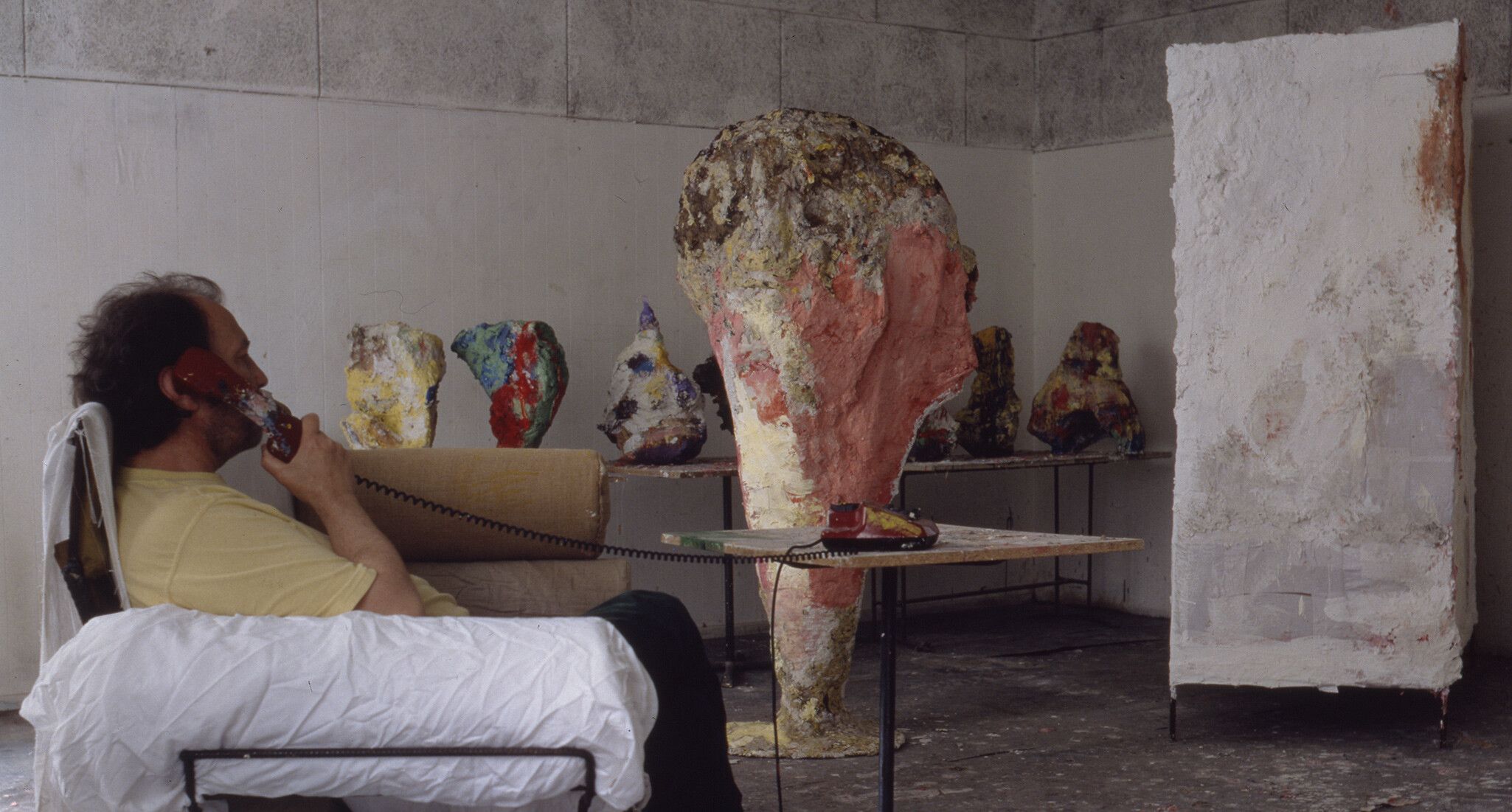 A photo of Franz West in his studio in 1995.