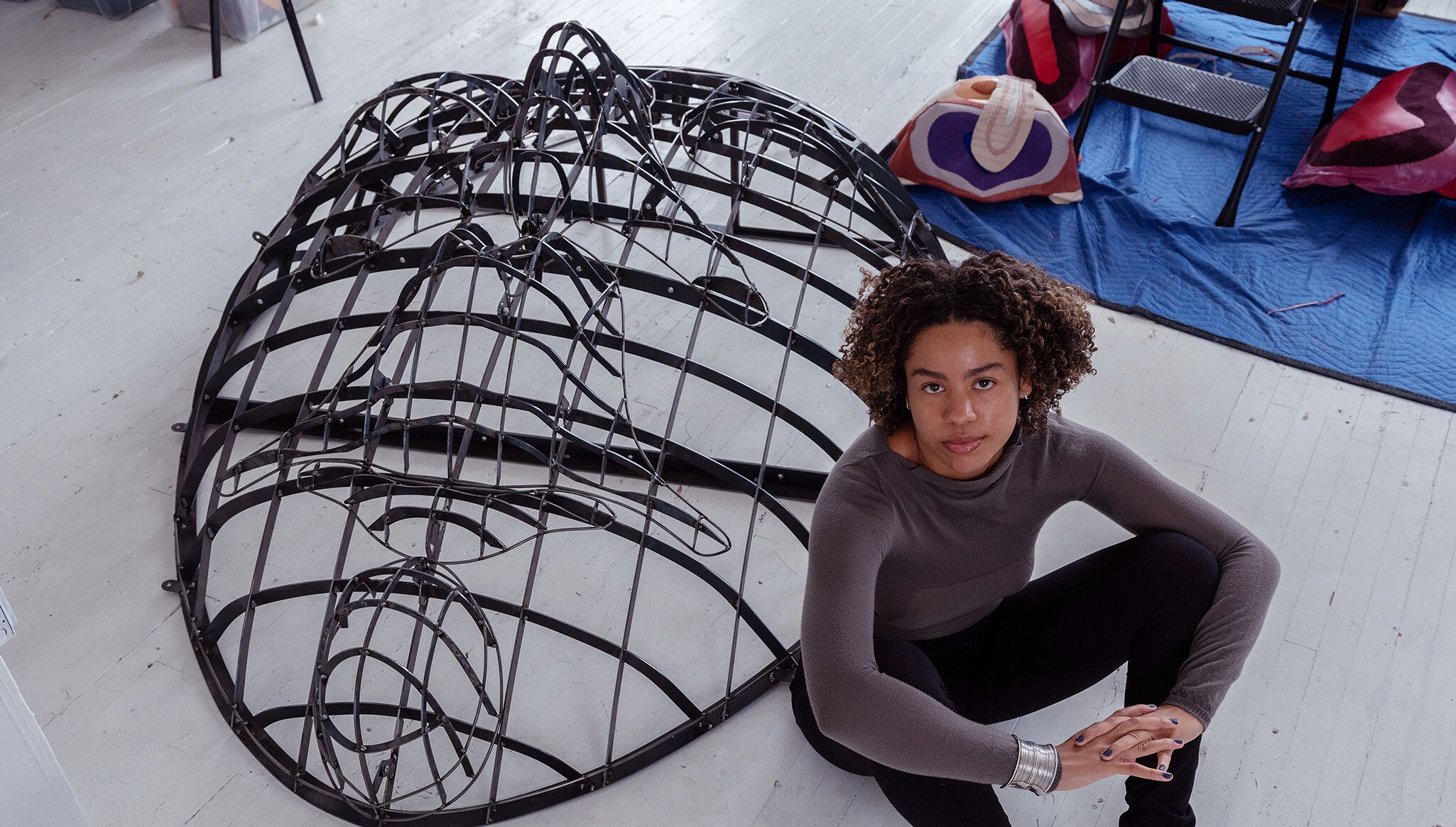 A photo of Tau Lewis in her studio, dated 2022.