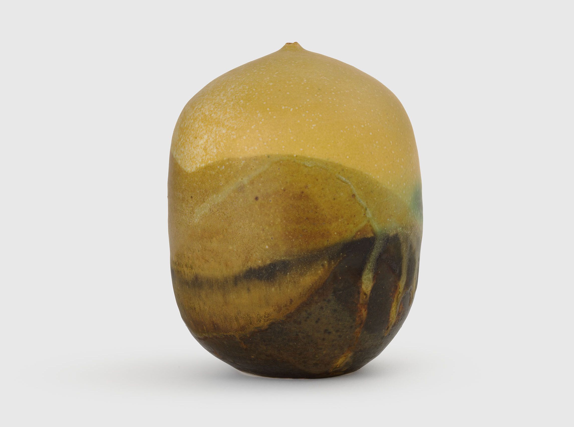 A sculpture by Toshiko Takaezu, called Untitled, Yellow Closed Form, 1990 to 1999.