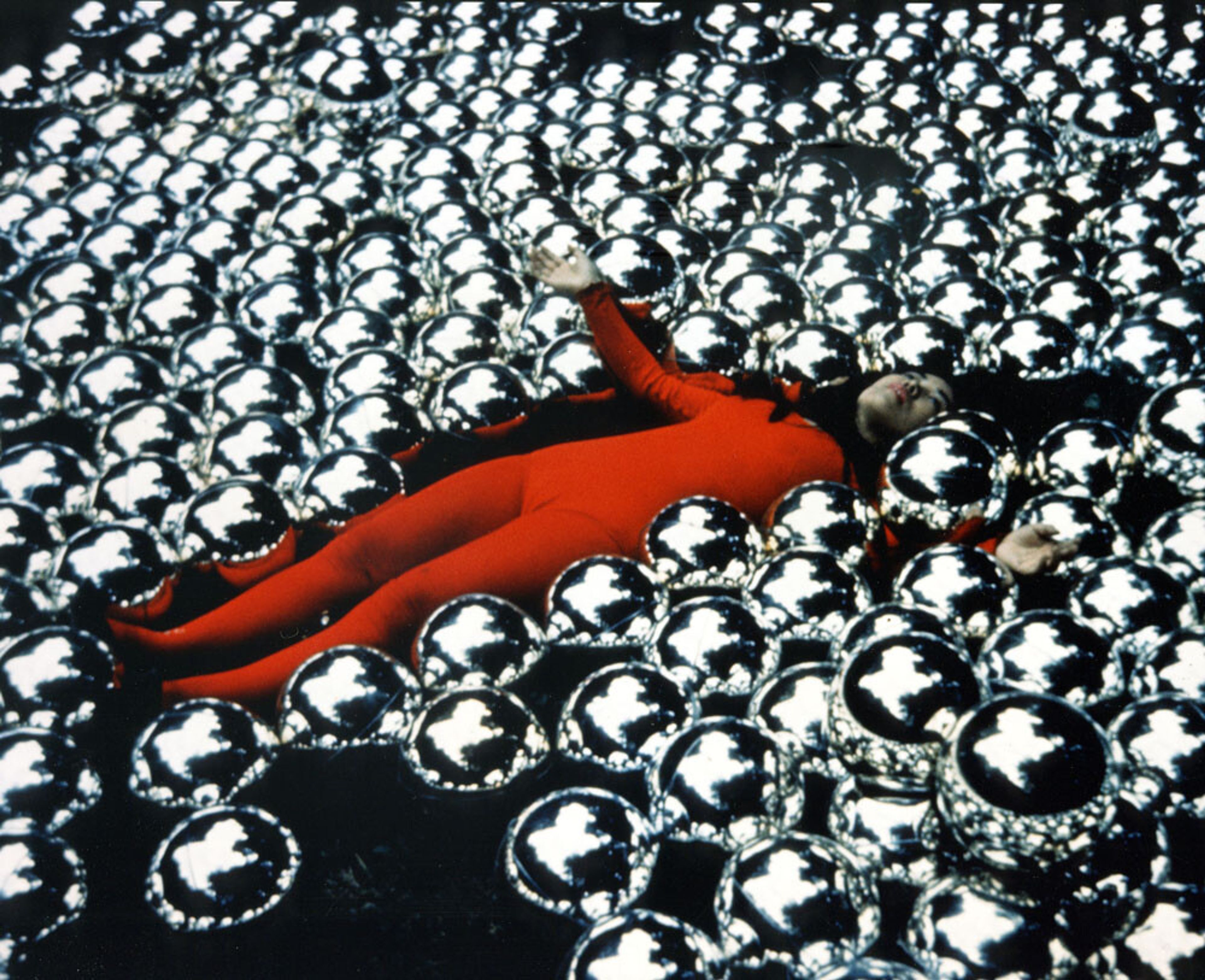 A photograph of Yayoi Kusama with¬†her installation titled Narcissus Garden at the 33rd¬†Venice Biennale, in 1966.