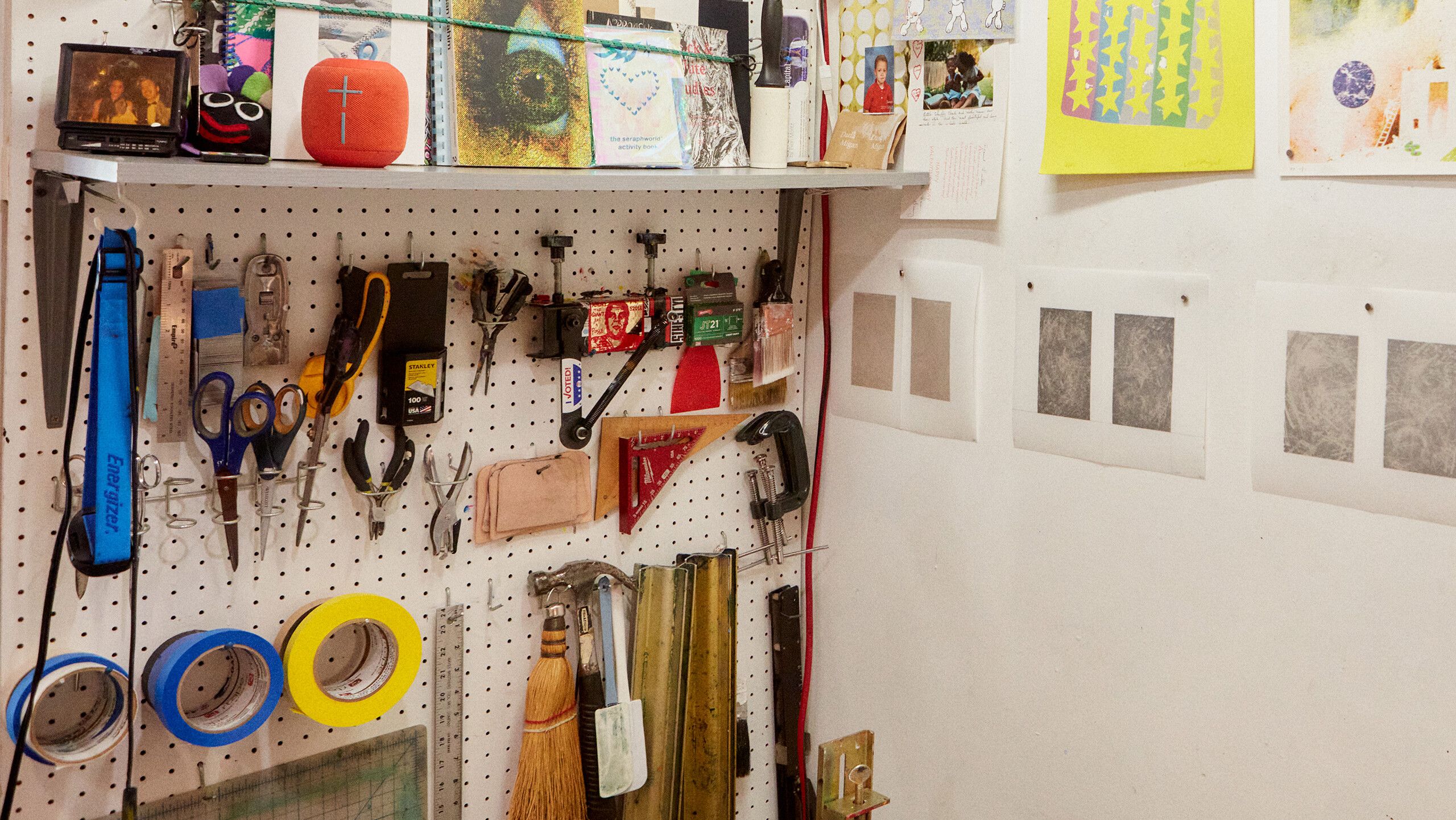 A photograph of Du-Good Press’s wall of tools, and proofs for artist Nikita Gale’s print on the wall, at right, by Rafael Rios, dated 2022.