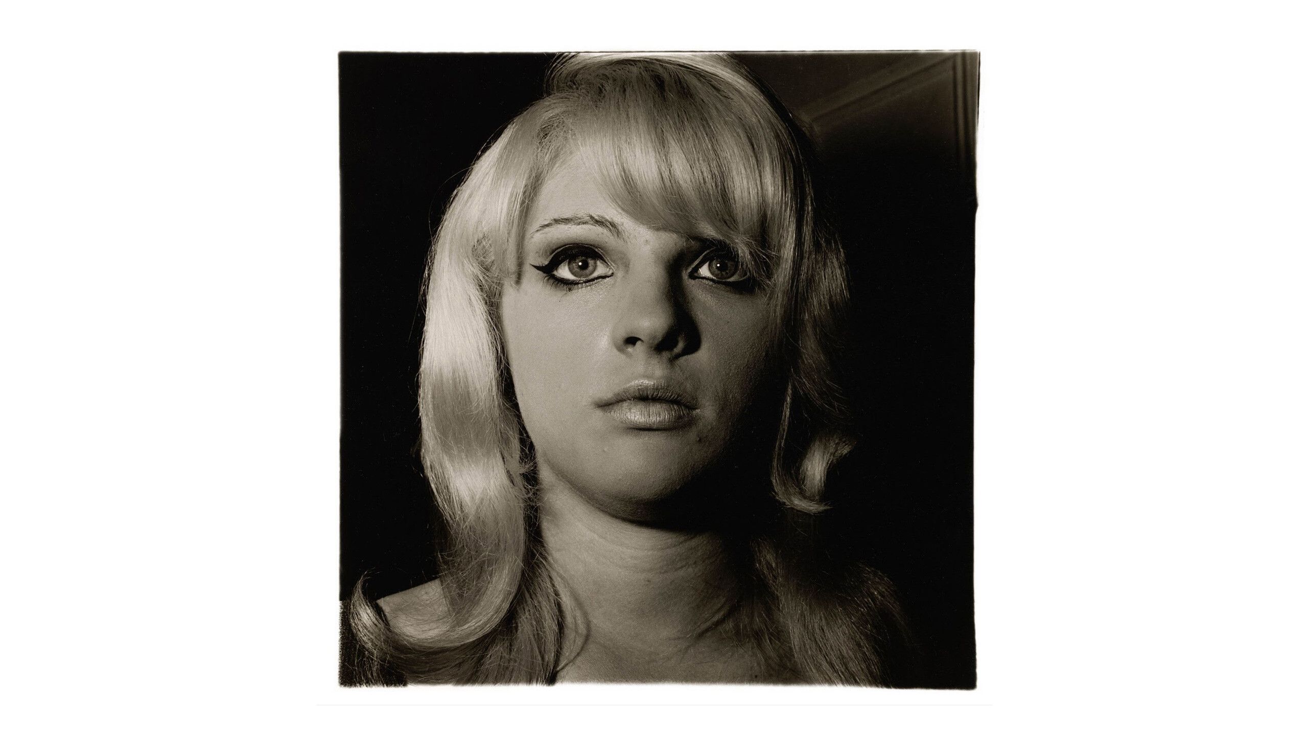 A photograph titled Blonde girl with shiny lipstick, N.Y.C. 1967 by Diane Arbus