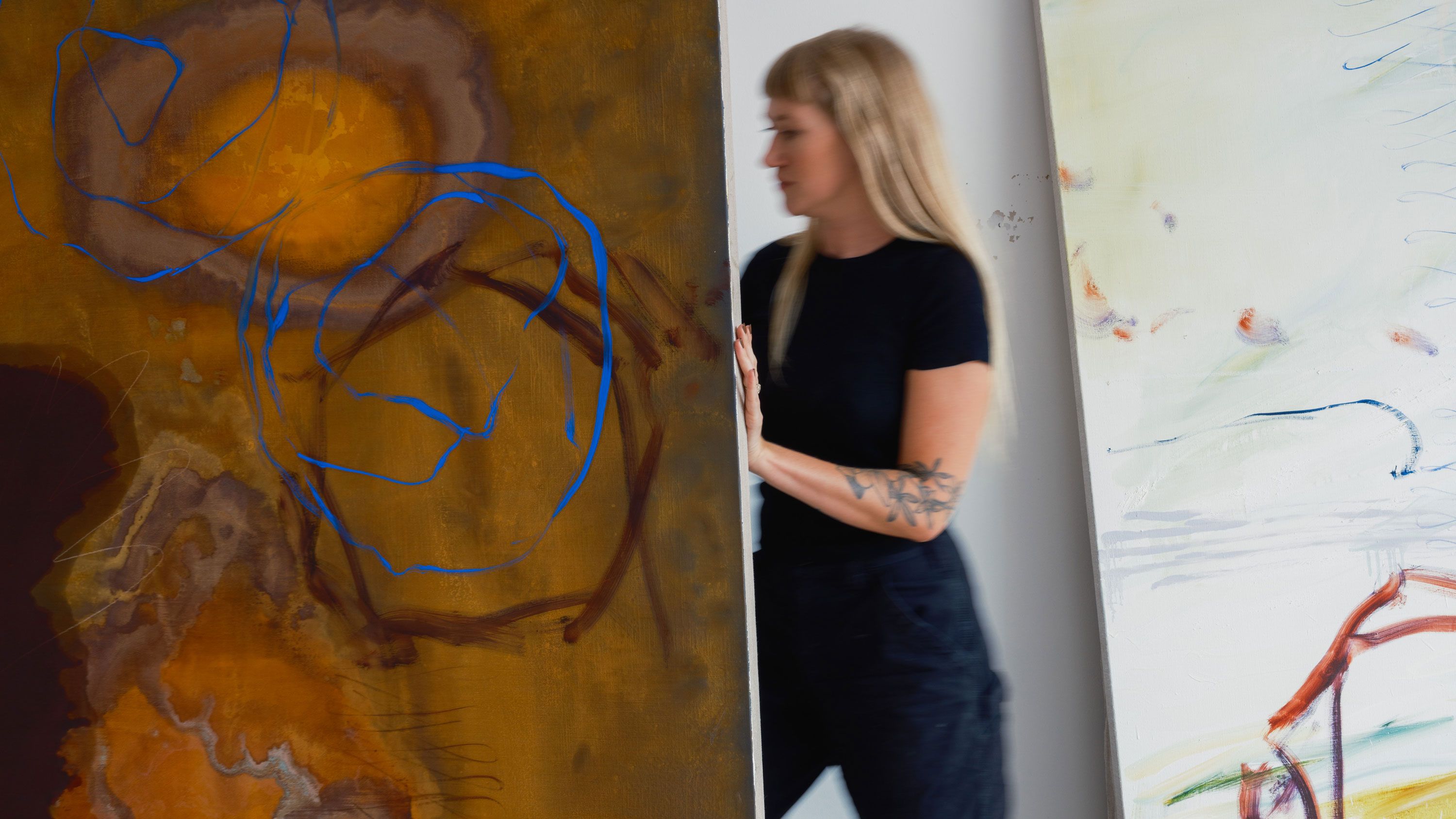 A photo of Emma McIntyre in her studio with Duets in the dust, 2023. Photo by Chantal Anderson