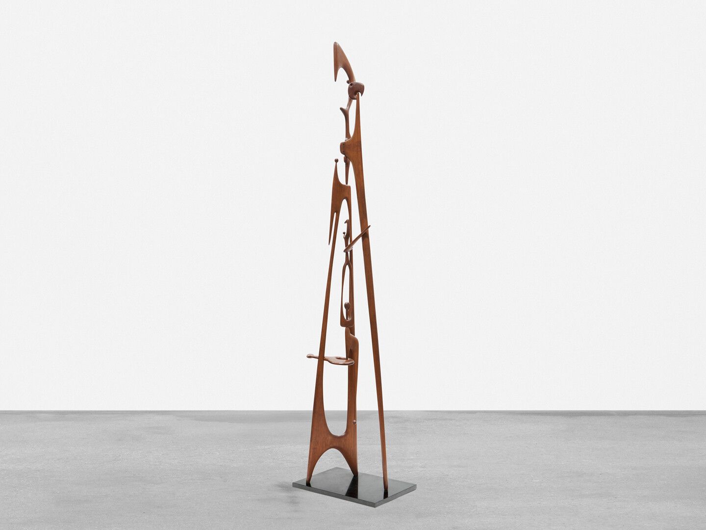 A wood and granite sculpture by Leo Amino, titled, Family Totem, dated 1951. 