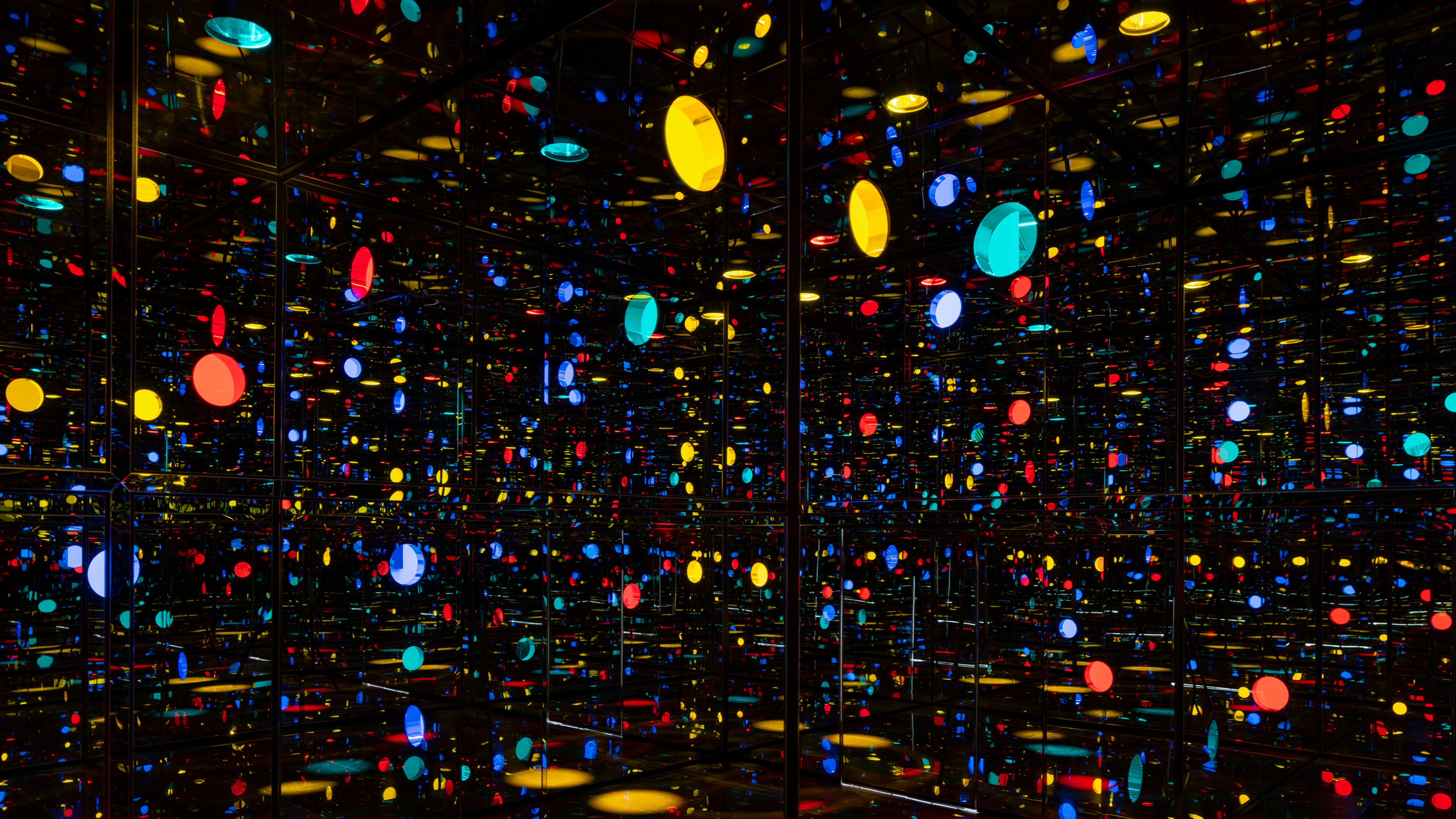 Yayoi Kusama’s Illusion Inside the Heart, an Infinity Mirrored Room filled with colorful lights and reflections.