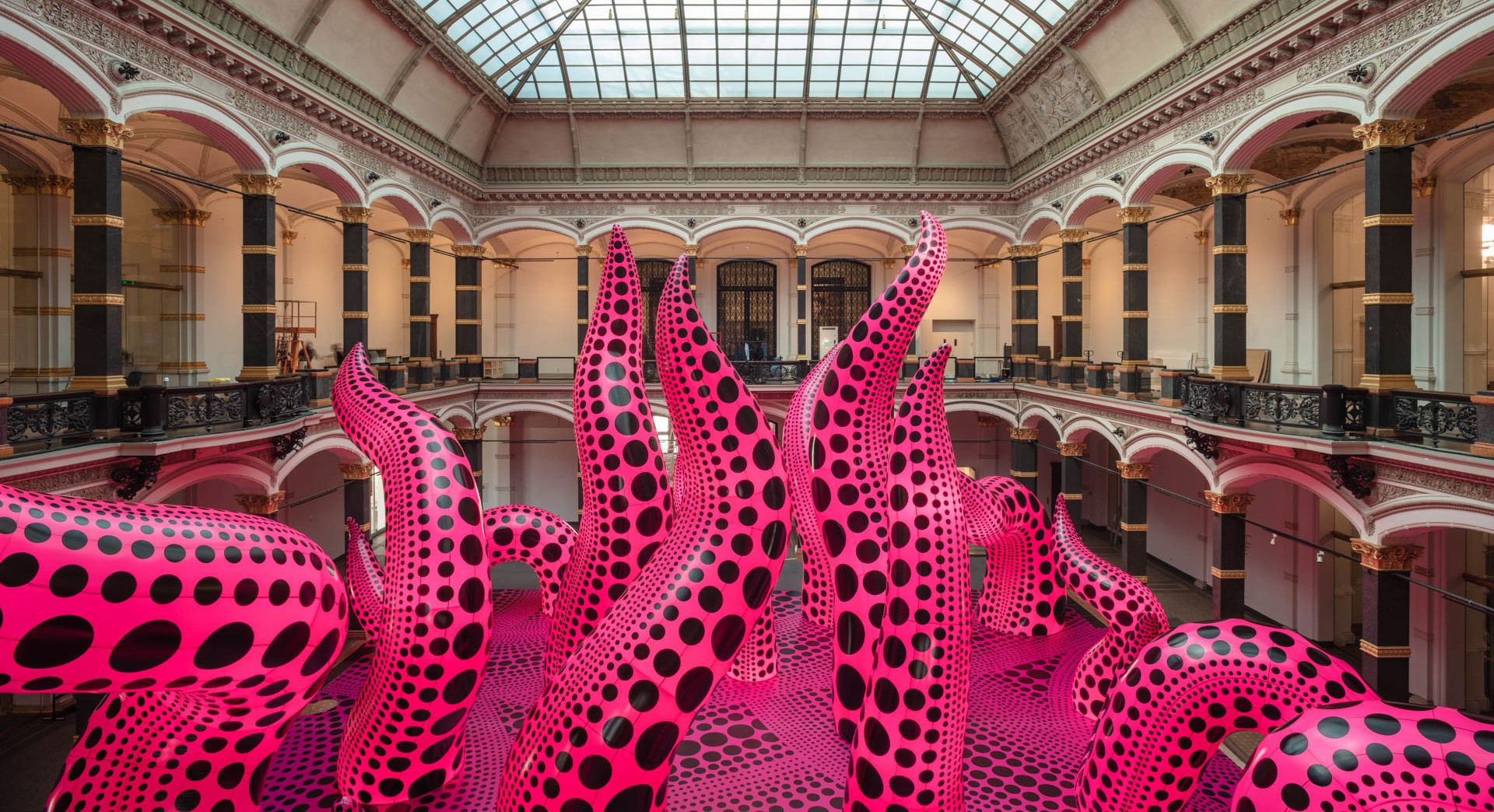 An installation view of an exhibition titled Yayoi Kusama: A Retrospective – A Bouquet of Love I Saw in the Universe, at Gropius Bau in Berlin in 2021.