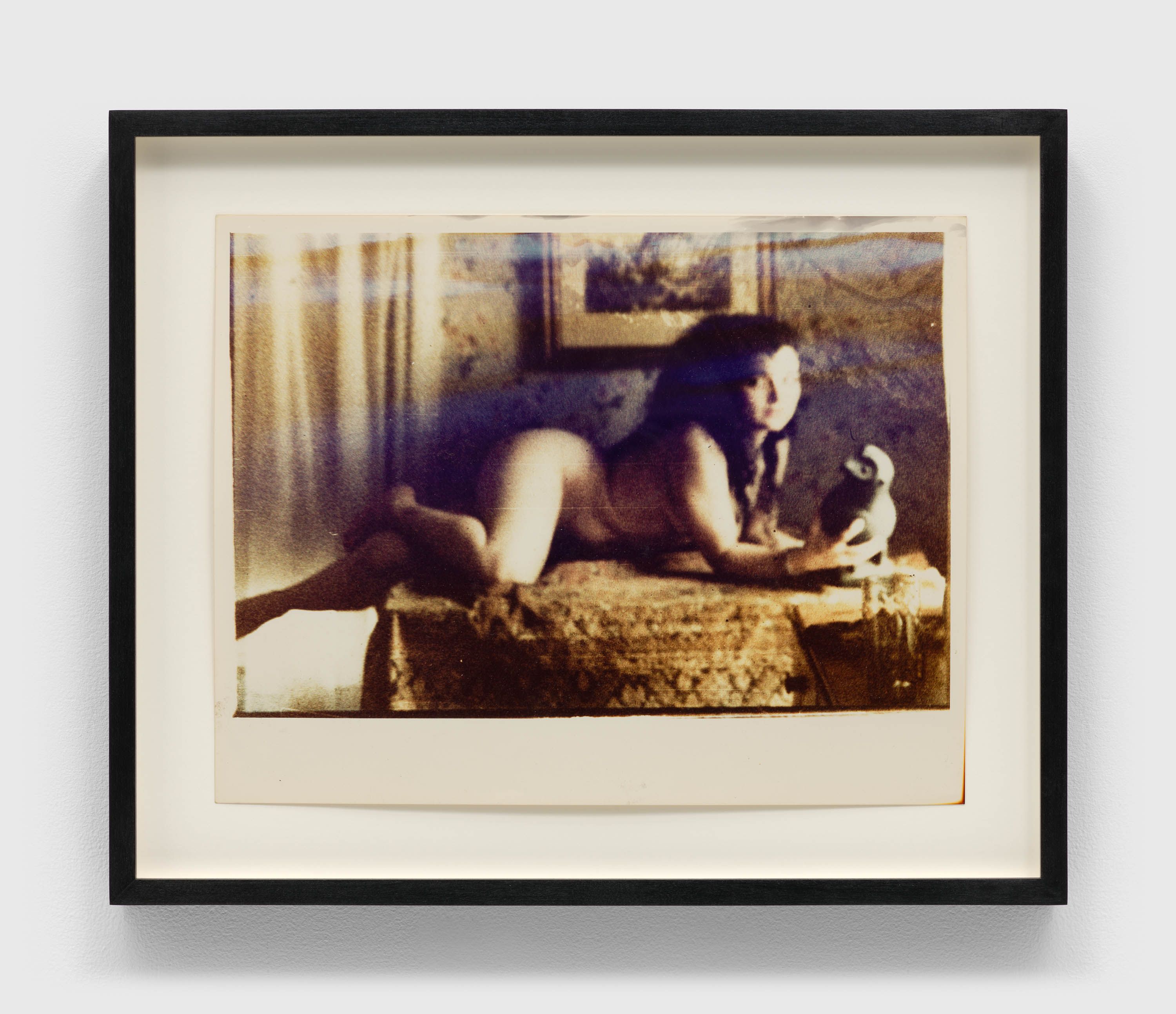 A photograph by Mark Morrisroe, titled Untitled, Lynelle Contemplates the Bird, dated 1985.
