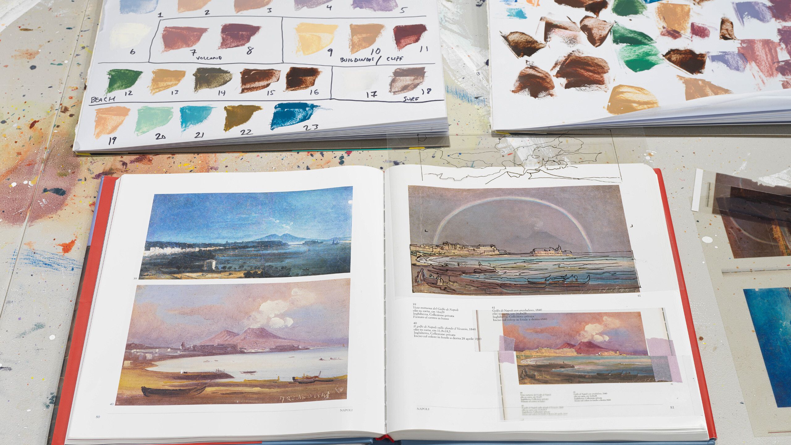 A view of Nate Lowman’s studio featuring an open book with Ippolito Caffi’s color studies of Mount Vesuvius. Photo by Jeffrey Sturges
