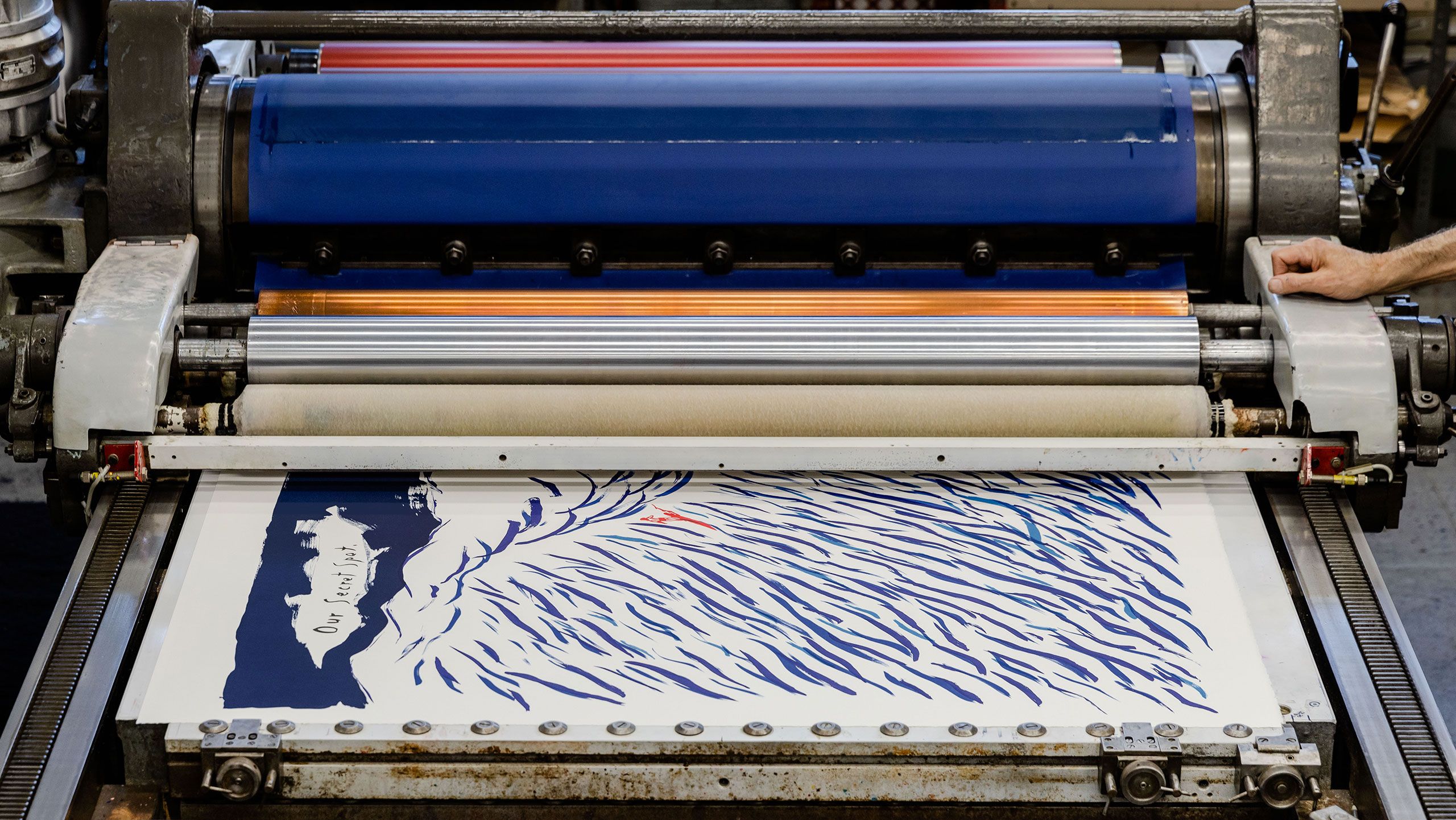 A photo of a print by Raymond Pettibon being printed, dated 2022.