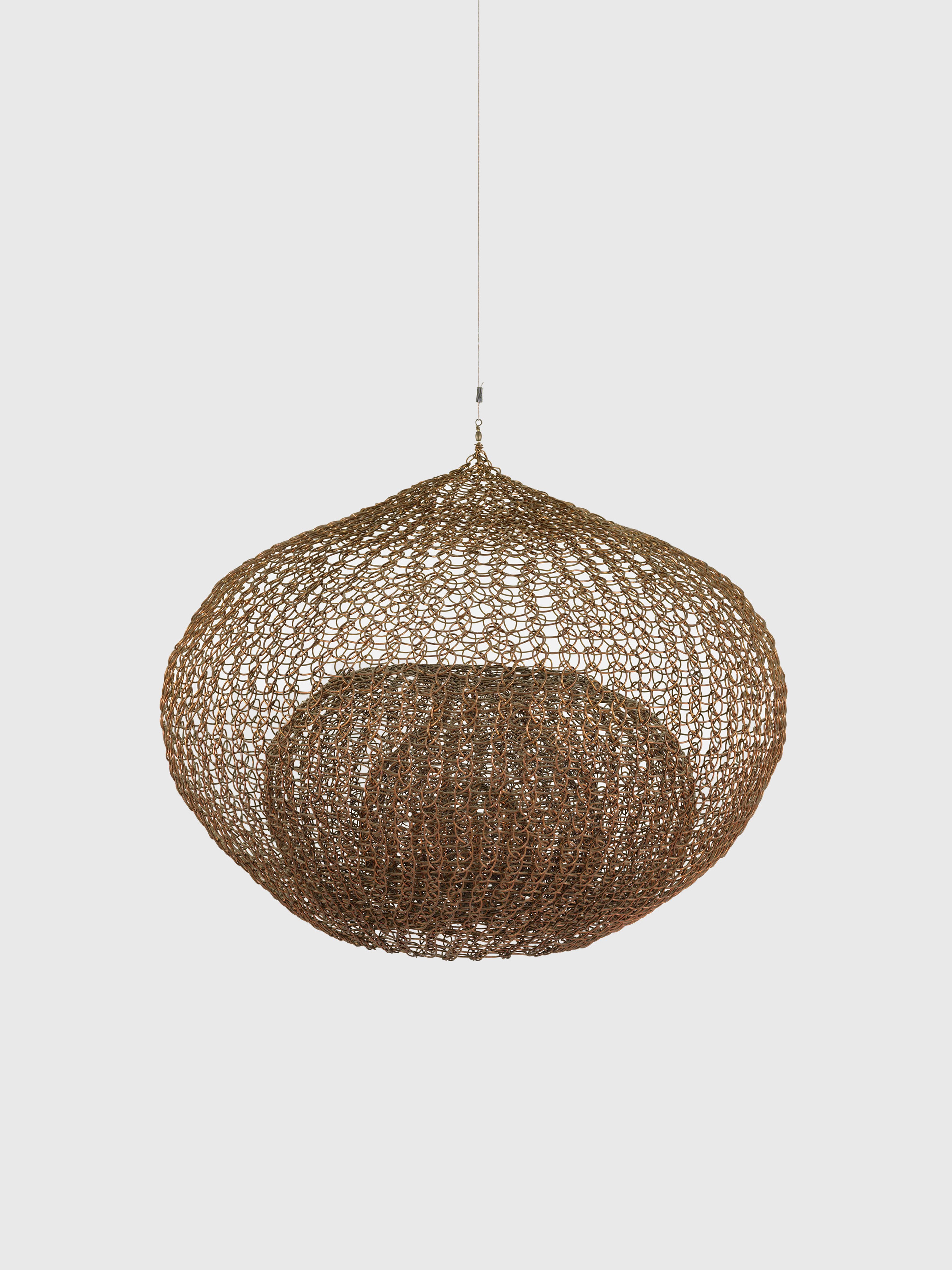 A sculpture by Ruth Asawa, called Untitled (S.175, Hanging Single-Lobed, Four-Layer Continuous Form within a Form), dated circa 1992.