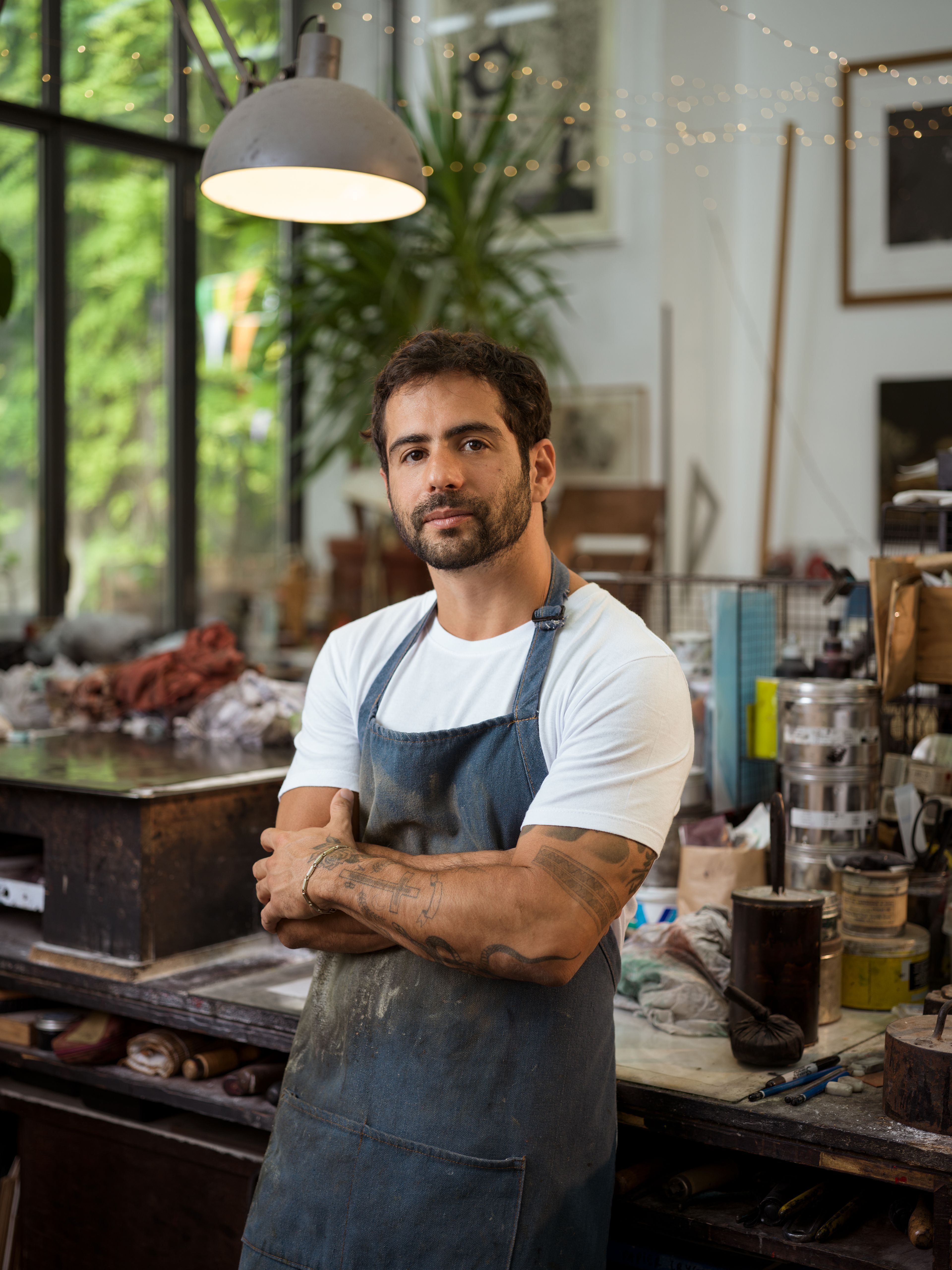 A photograph of Lucas Arruda in his studio by Jason Schmidt, dated 2020