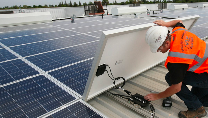 man installing solar inverter