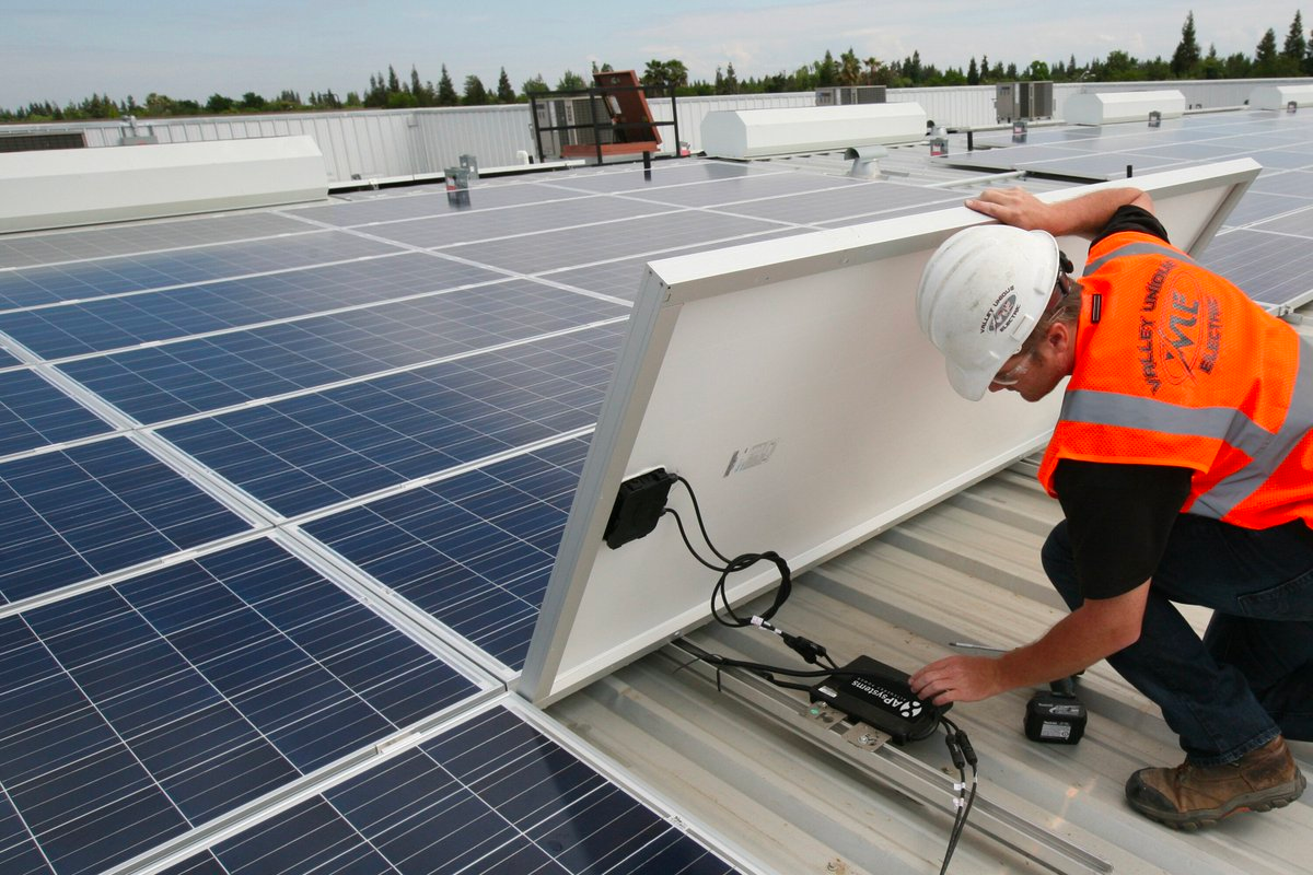man installing solar inverter