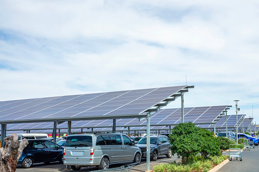 Cars parked under a solar panel carport parking lot