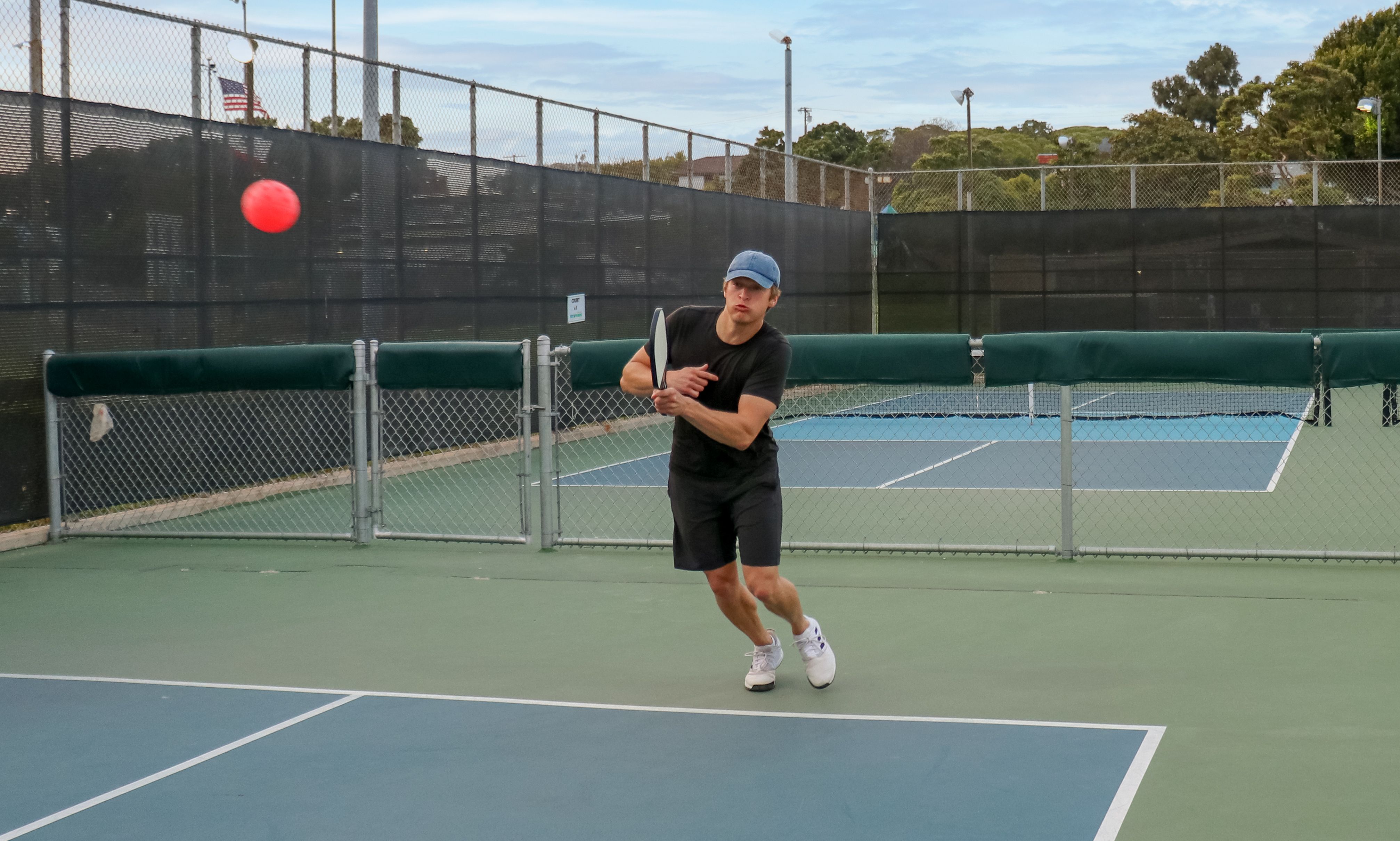 Pickleball player returning a difficult shot