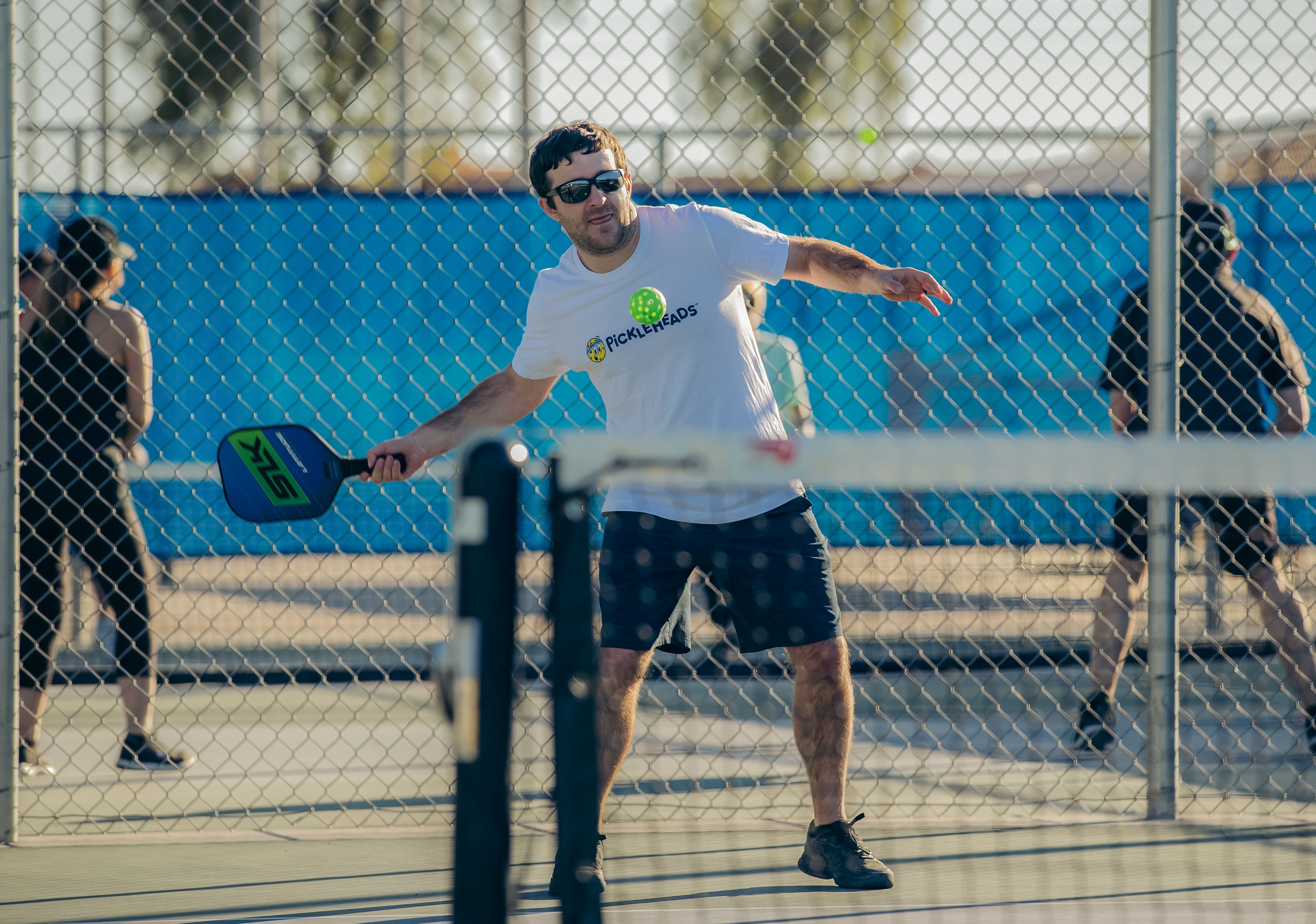 Player concentrates on a shot during a pickleball game