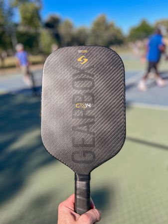 Holding the Gearbox CX14E pickleball paddle after 10 hours of testing by Brandon Mackie.