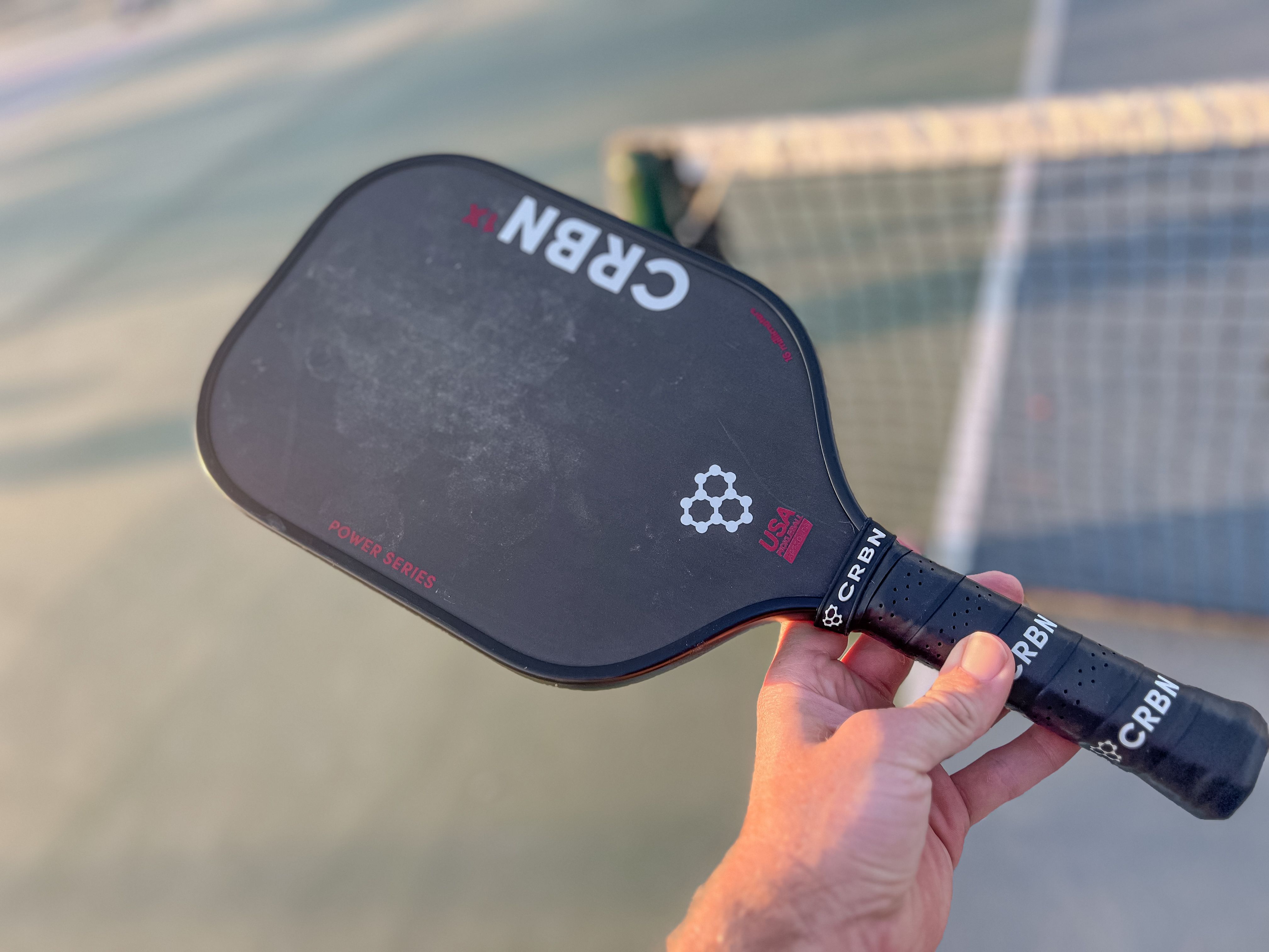 Brandon Mackie shows off the design of the CRBN-1X Power Series pickleball paddle