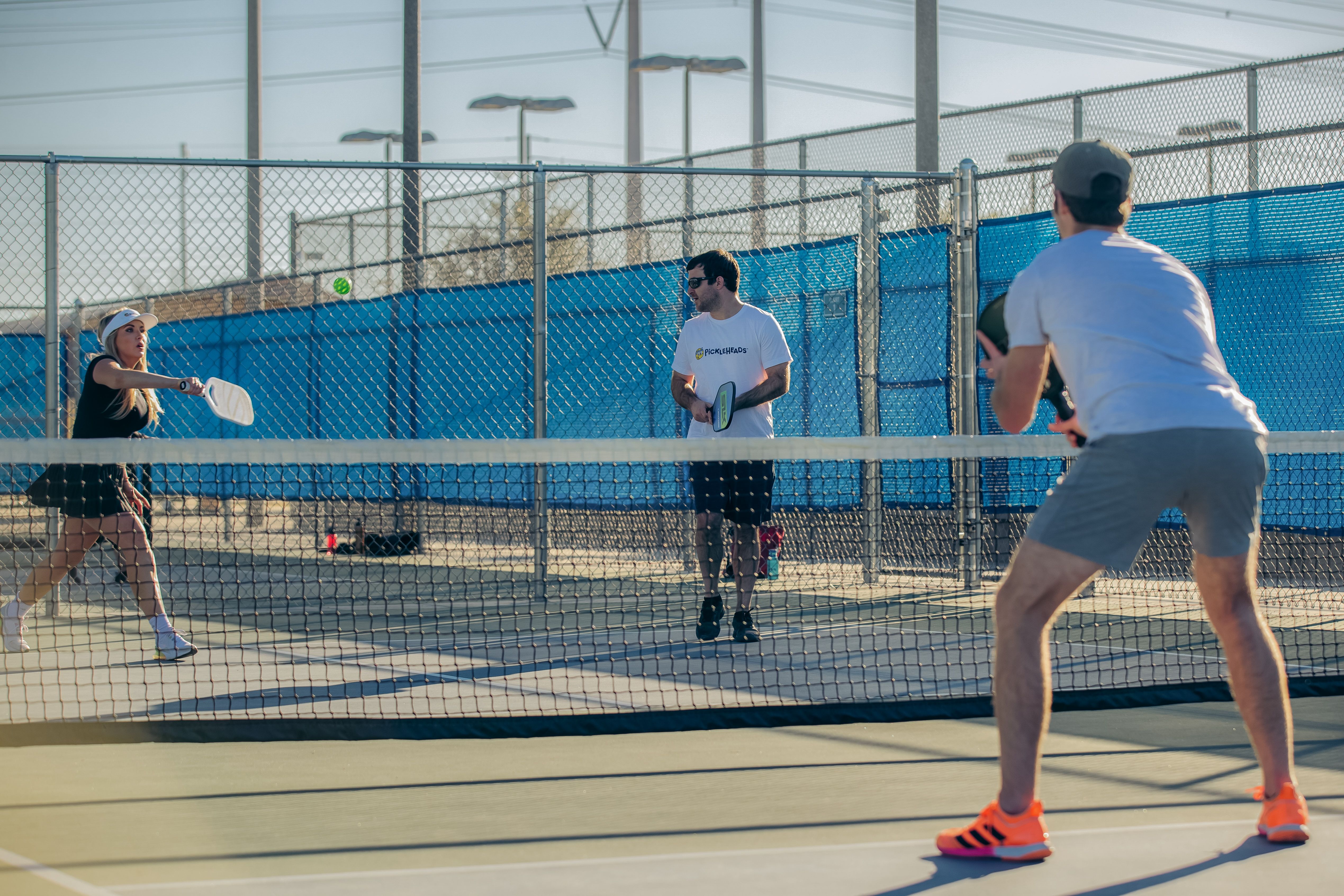 Players engaging in a game of doubles pickleball