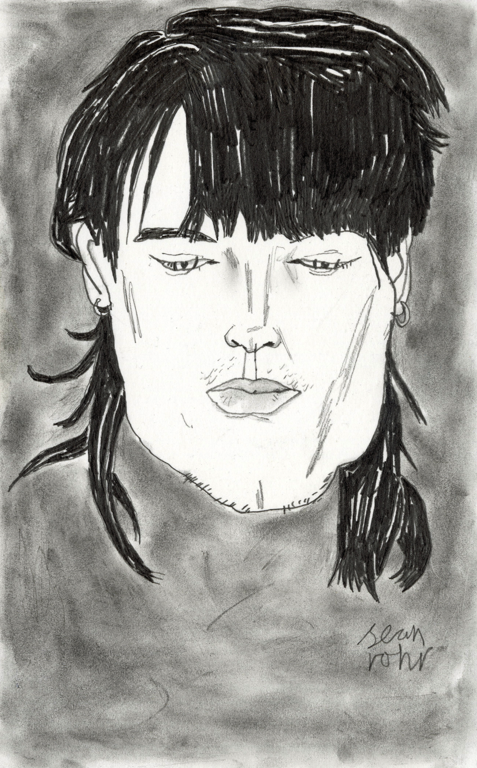 Portrait of a young man with dark hair looking down