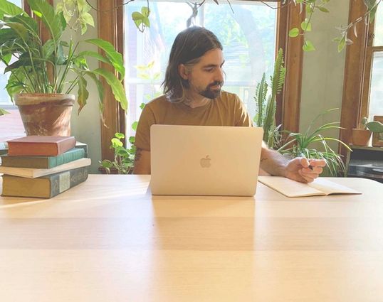 Niko at the table with books etc
