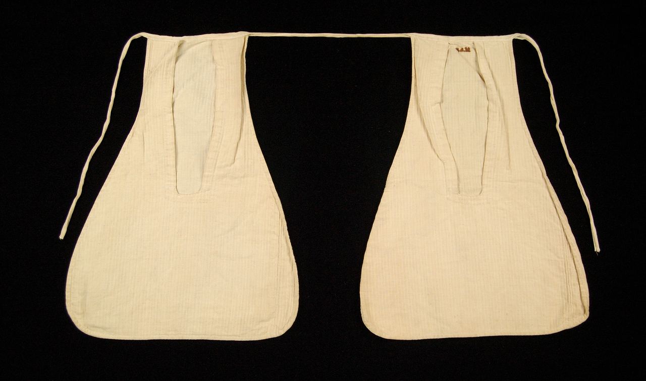 A pair of undyed linen tie-on pockets with a thin tape joining them at the top; each has a long opening that runs down from the waist and the fabric is finely ribbed.