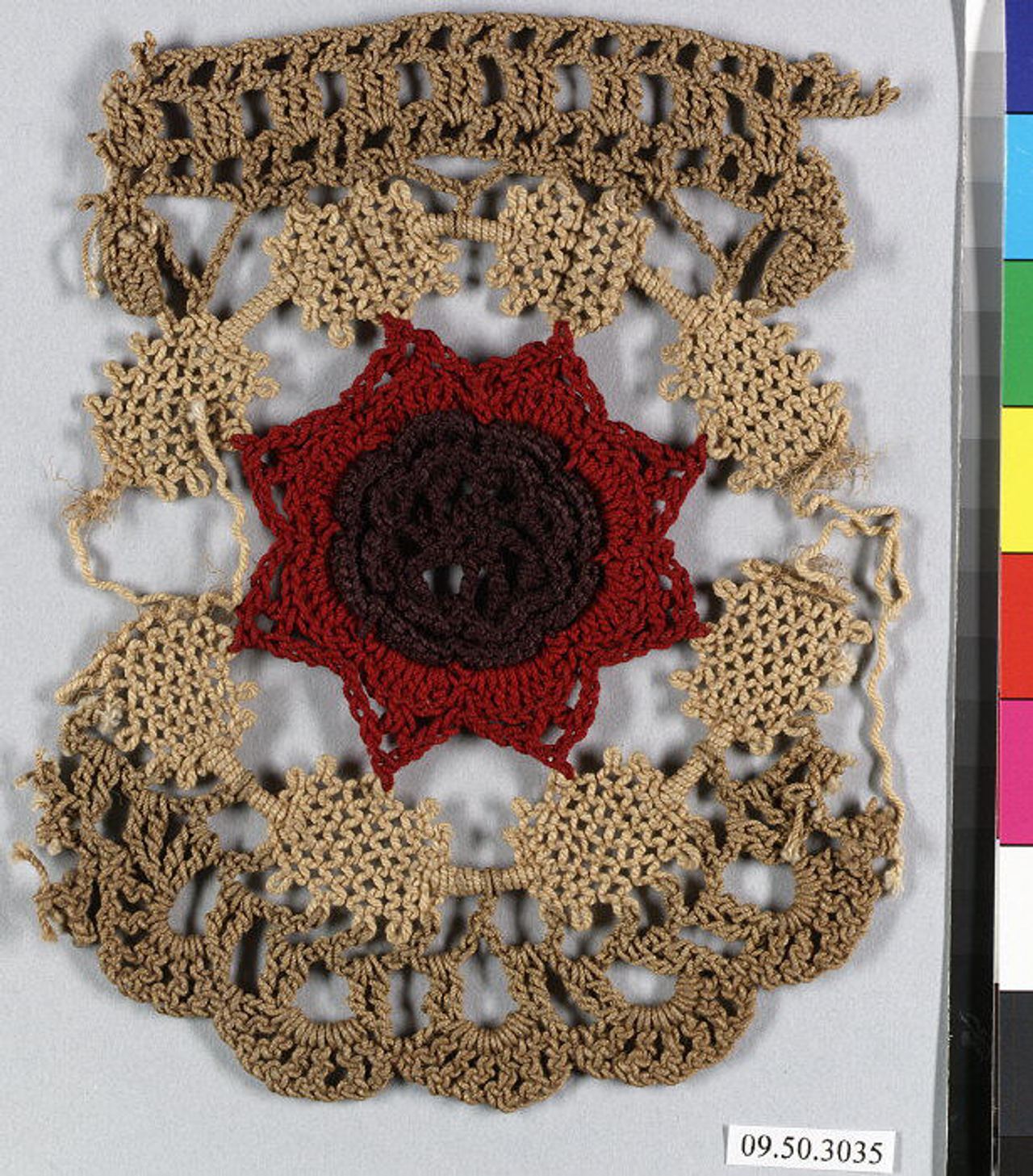A crochet sample in beige and red-brown thread. A red eight-pointed star with a dark brown rosette at its center sits in a ring of beige mesh patches, with an open-work band along the top and scallops at the bottom.