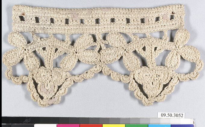 A cream-colored crochet border on a gray ground. A solid band along the top has a row of small square openings; below it hang leaf-like and trefoil motifs joined by scalloped loops, with a small looped edge.