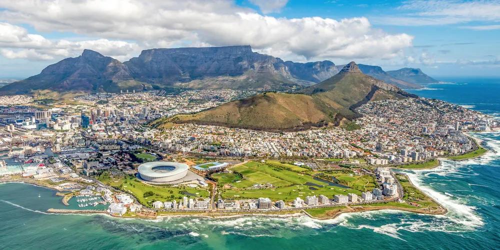 Aerial view of Cape Town coastline with Table Mountain, Lion’s Head, and Cape Town Stadium in South Africa
