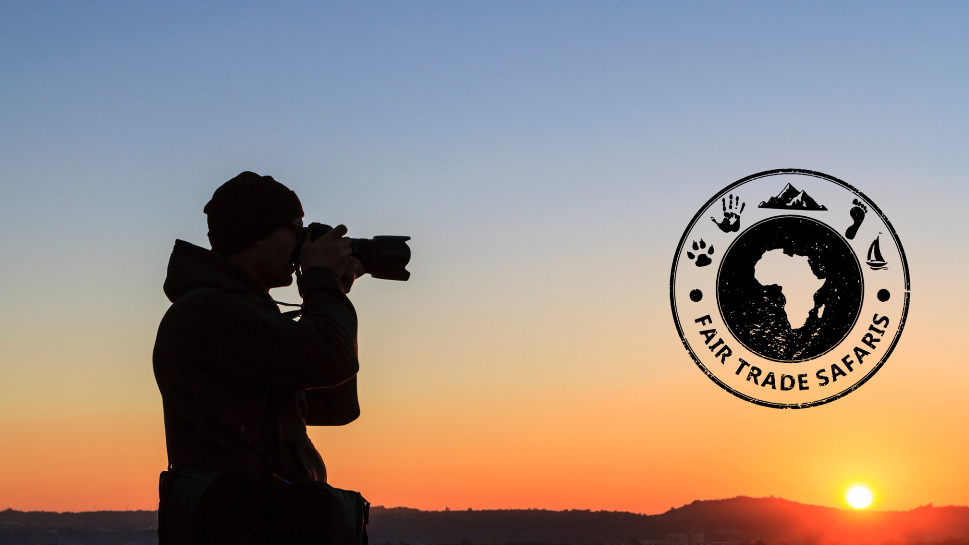 Silhouette of a photographer capturing a sunset over the horizon, with the Fair Trade Safaris logo featuring an outline of Africa displayed on the right.