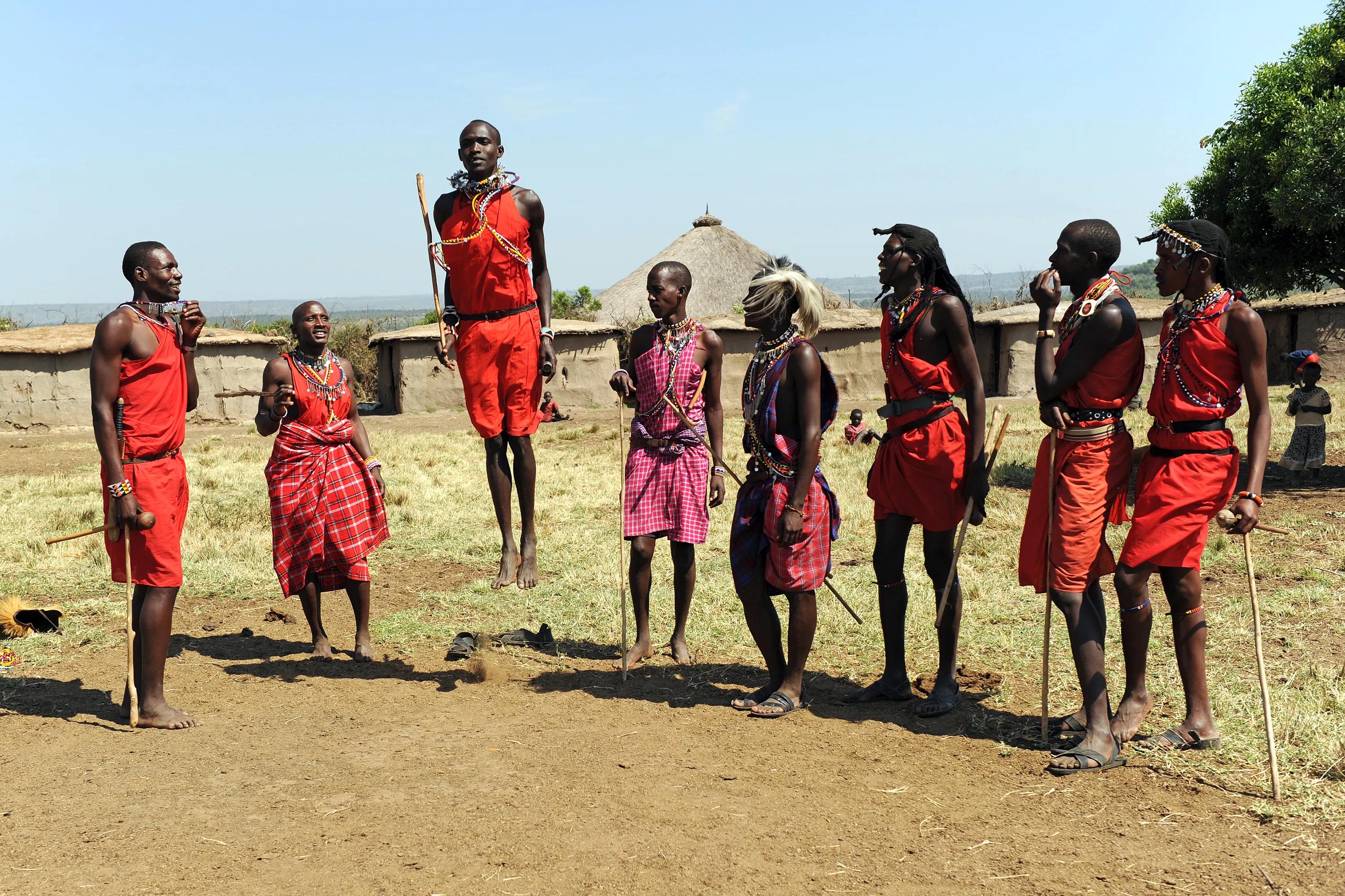 Maasai warriors performing traditional jumping dance in a rural Kenyan village