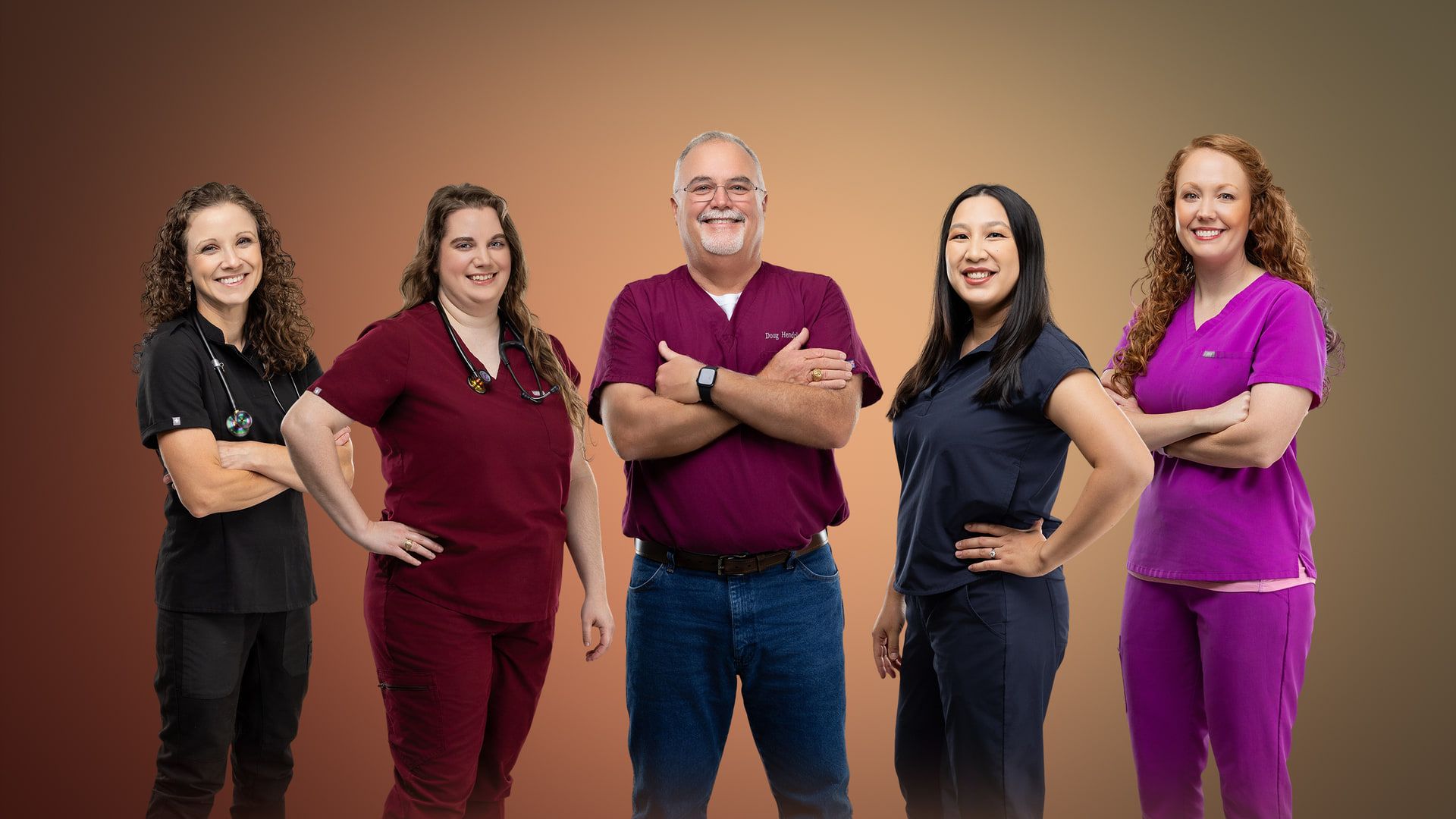 The five veterinarians of Sugar Land Pet Hospital standing together in scrubs