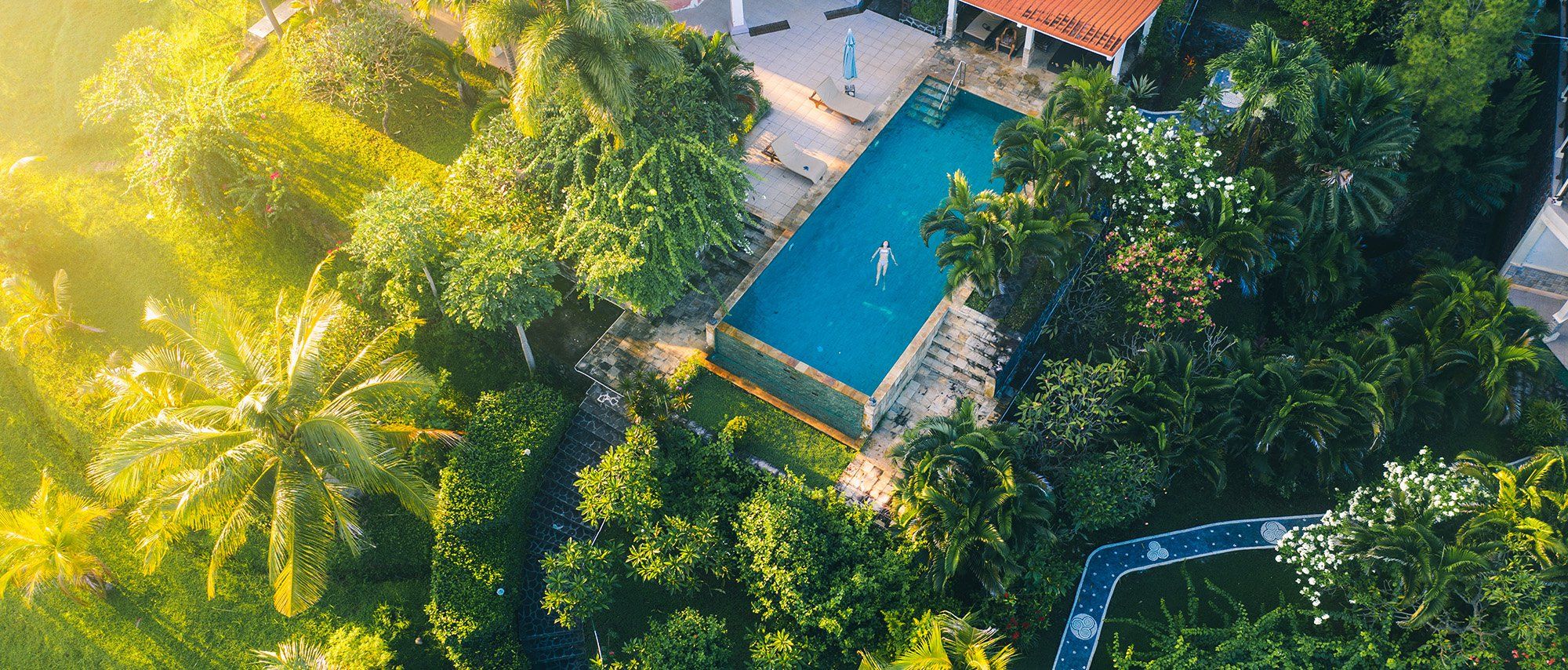 A beautiful infinity pool extends out over rice paddies in Bali