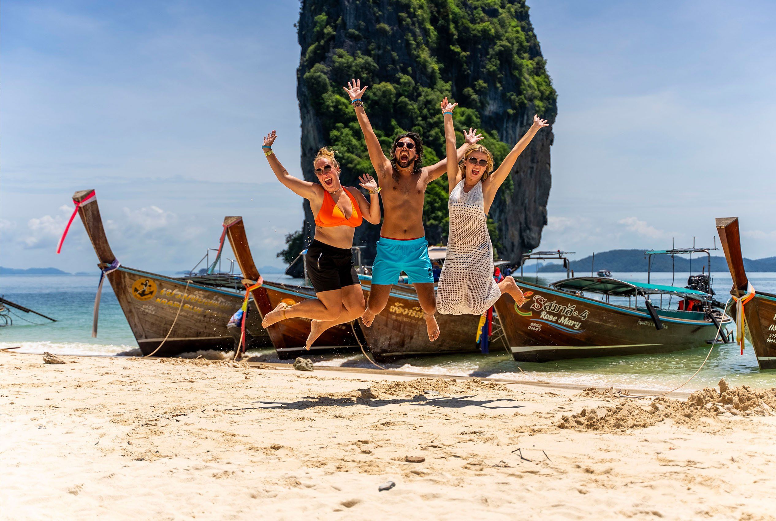 Group jumping in front if Thailand long boat