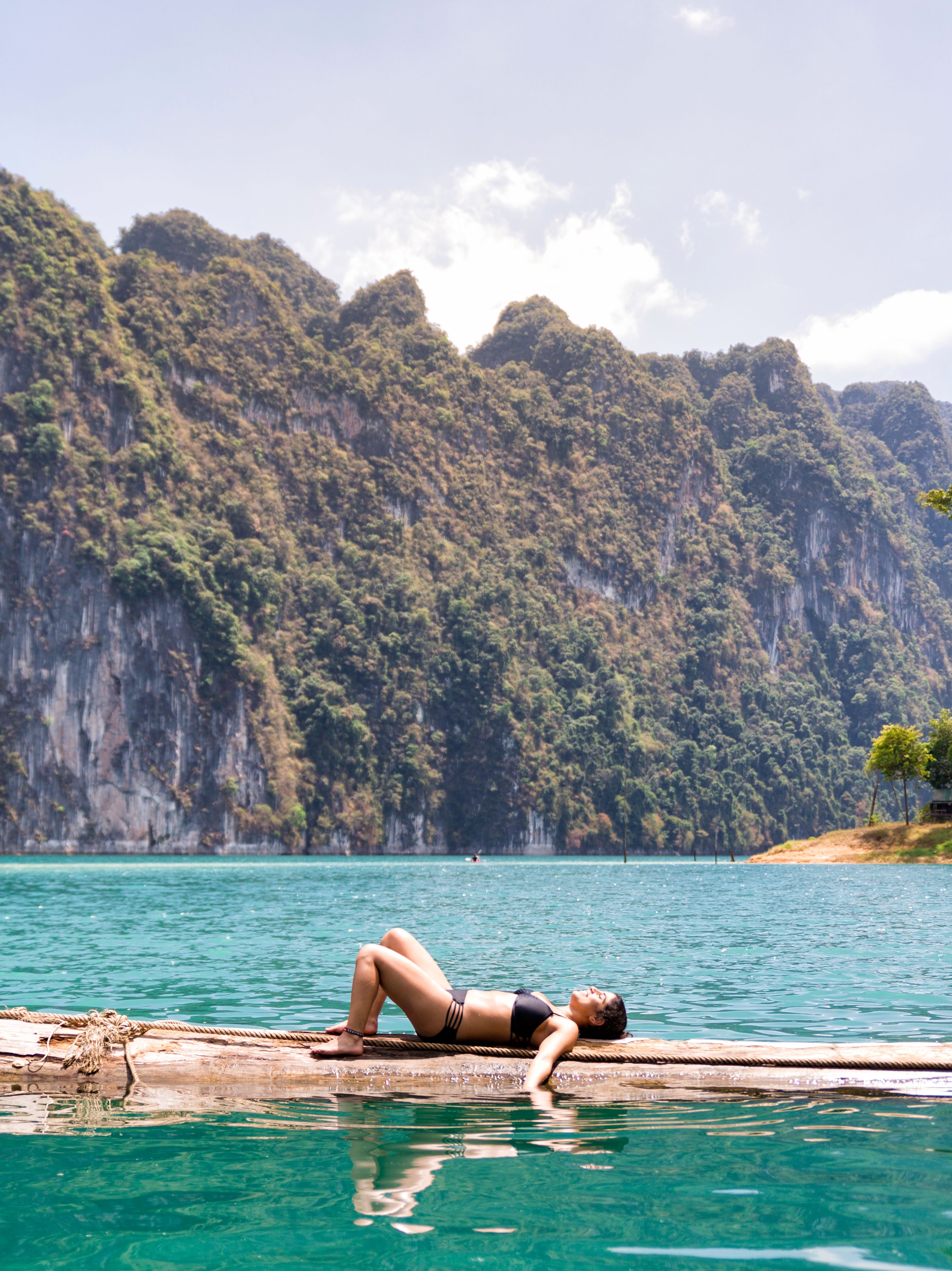 Thailand girl lazing on log in Khao Sok