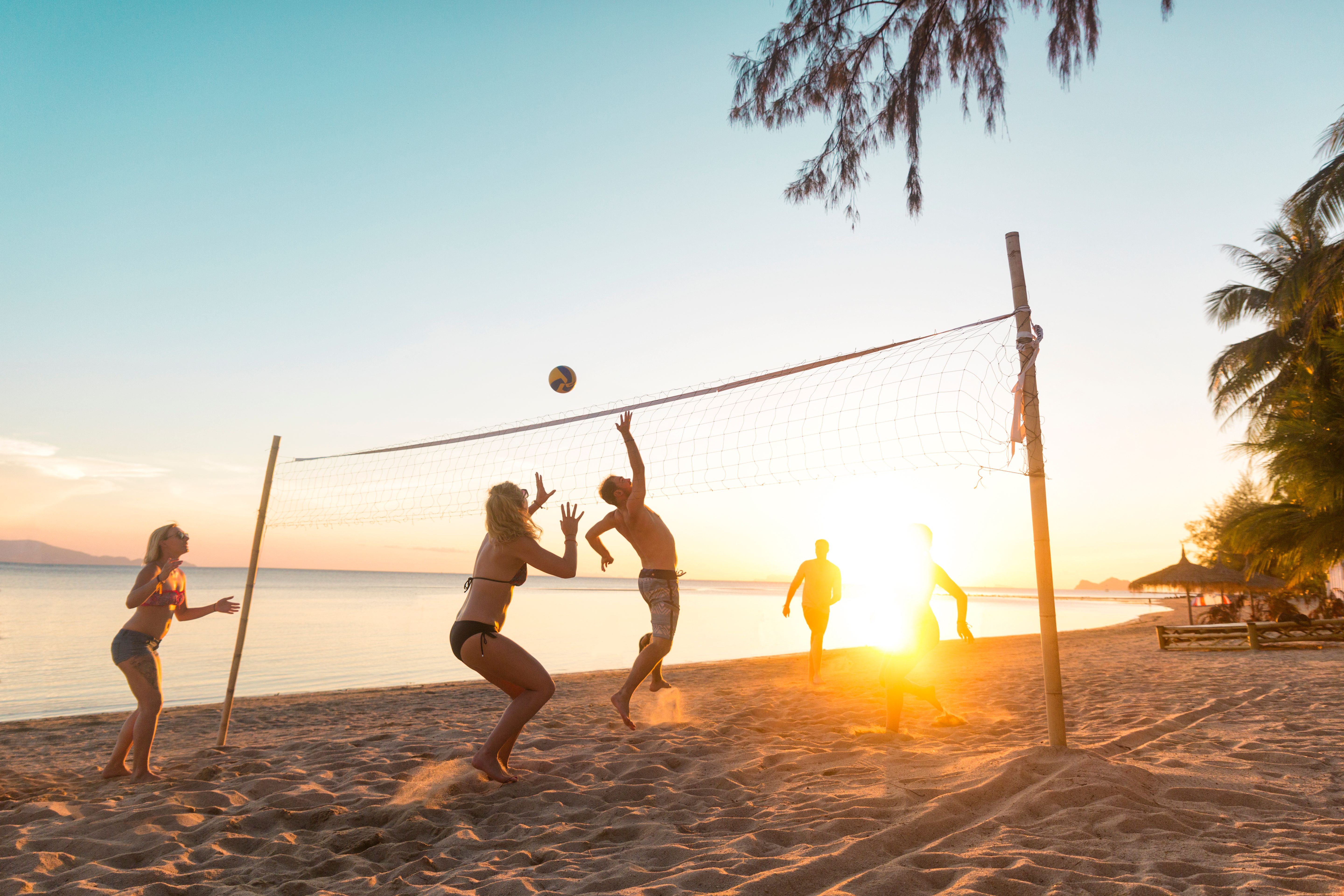 Beach volleyball at sunset