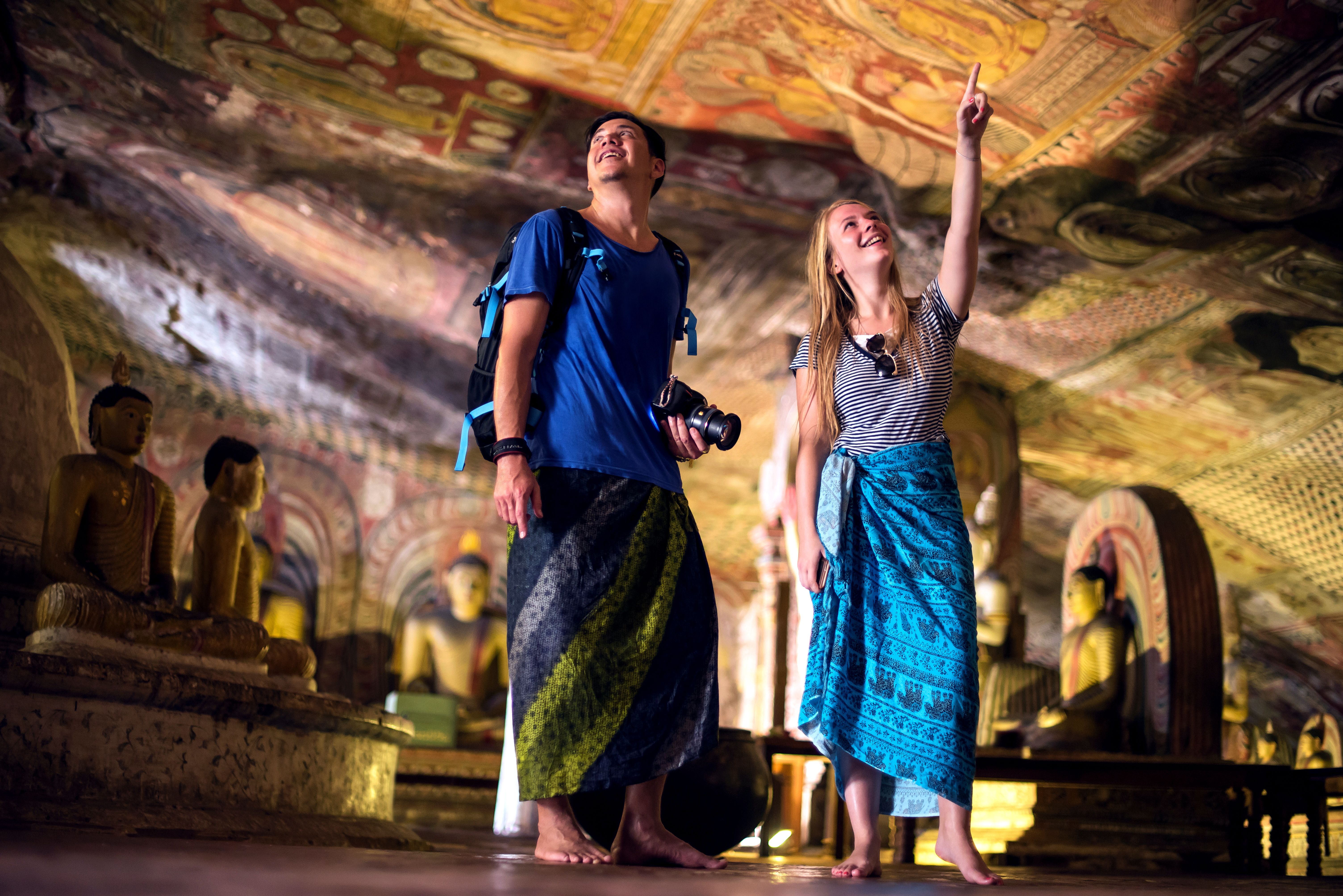 Two travellers view the Temple of the tooth in Sri Lanka