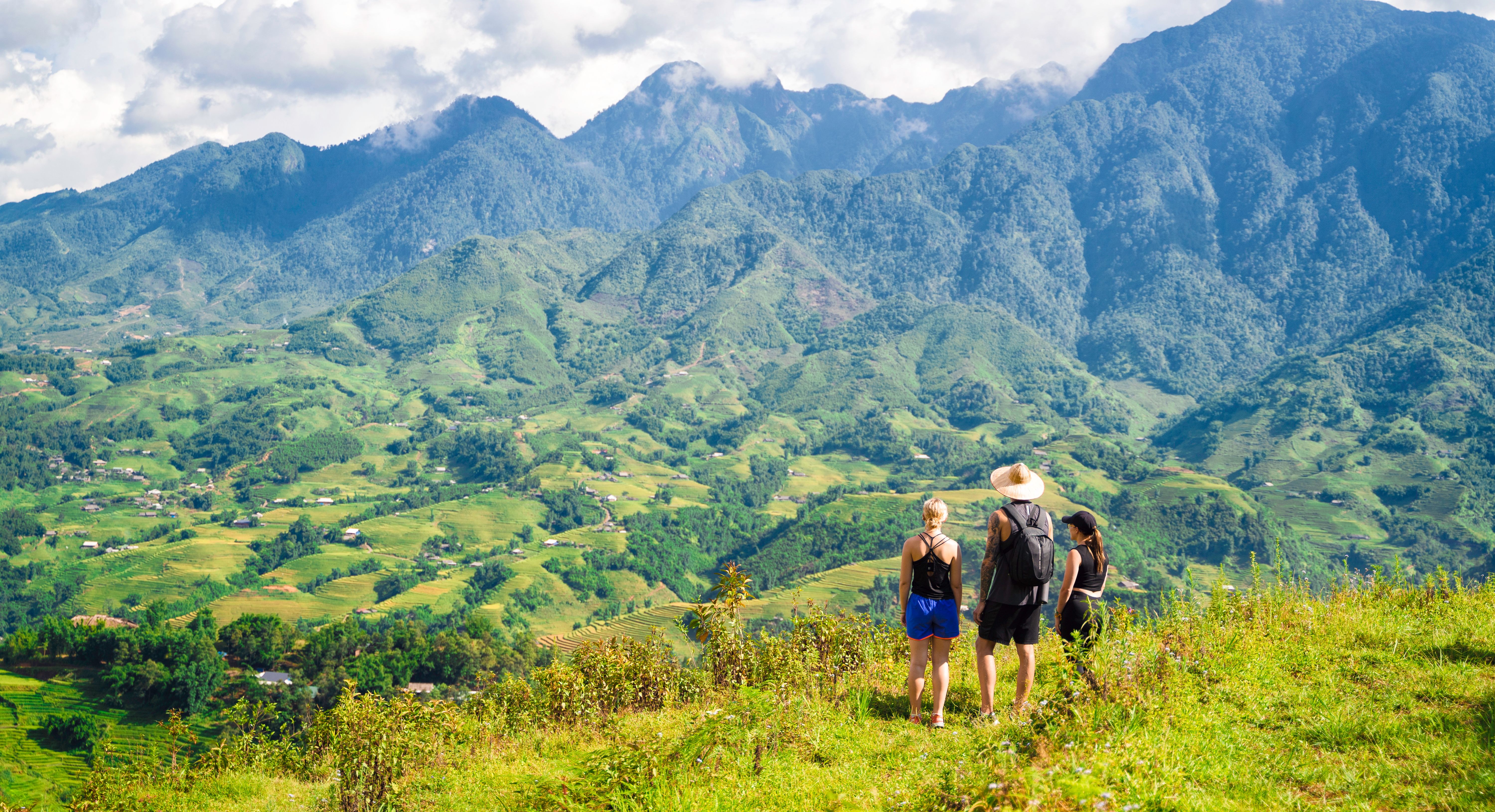 Travellers playing on a sandy Philippines beach next to a traditional boat