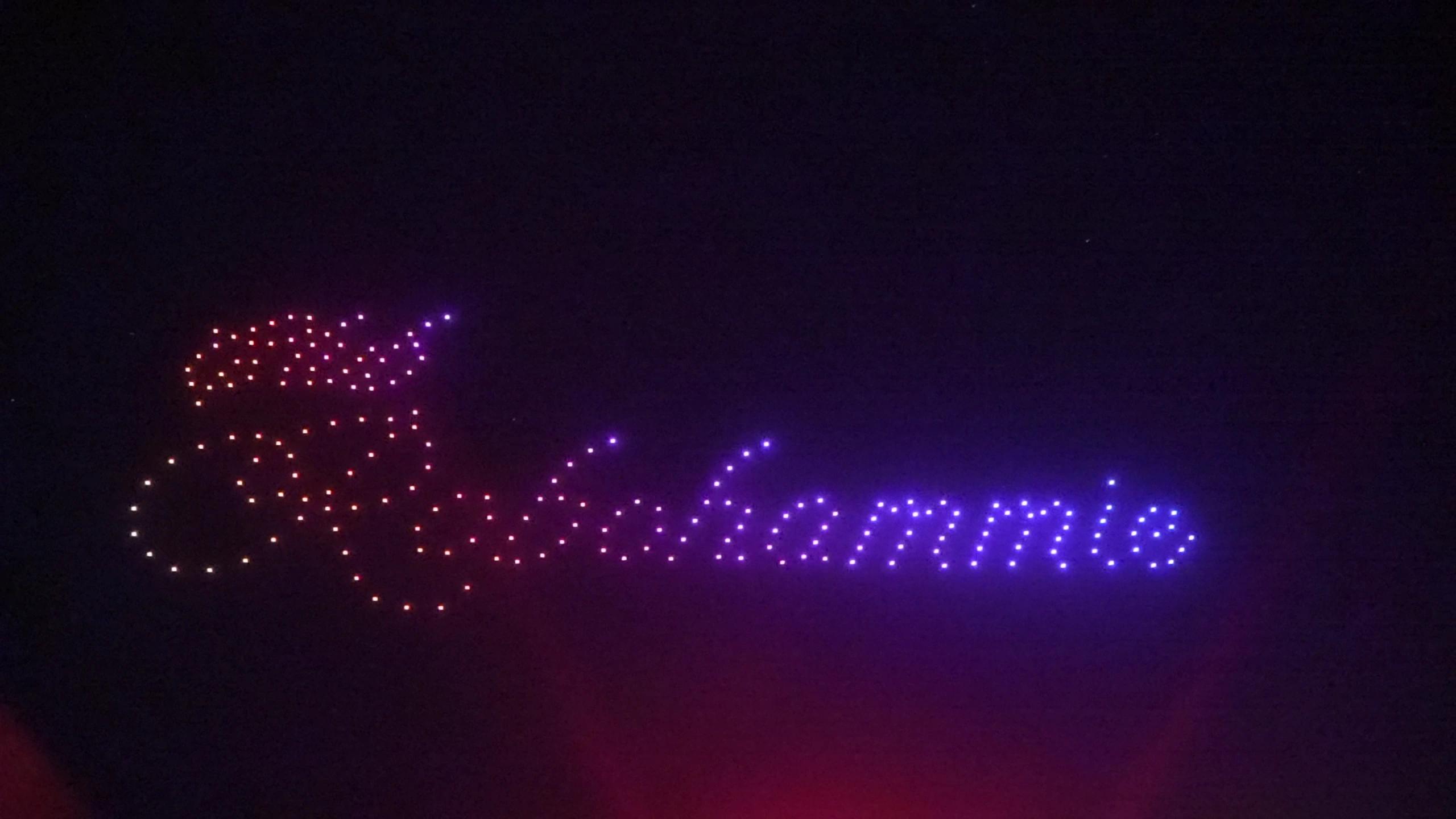 Christina written in colored drone lights above the wedding celebration at Alila Villas Uluwatu.