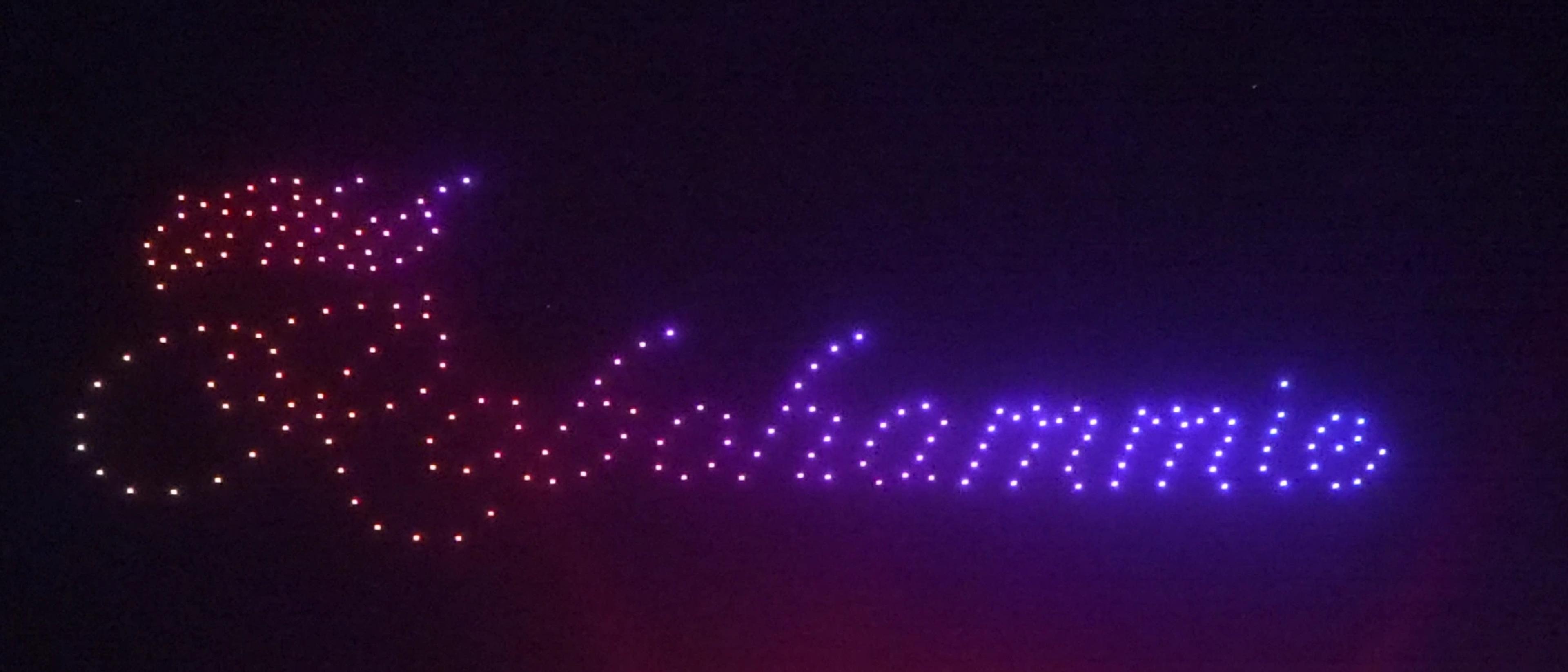 Christina written in colored drone lights above the wedding celebration at Alila Villas Uluwatu.