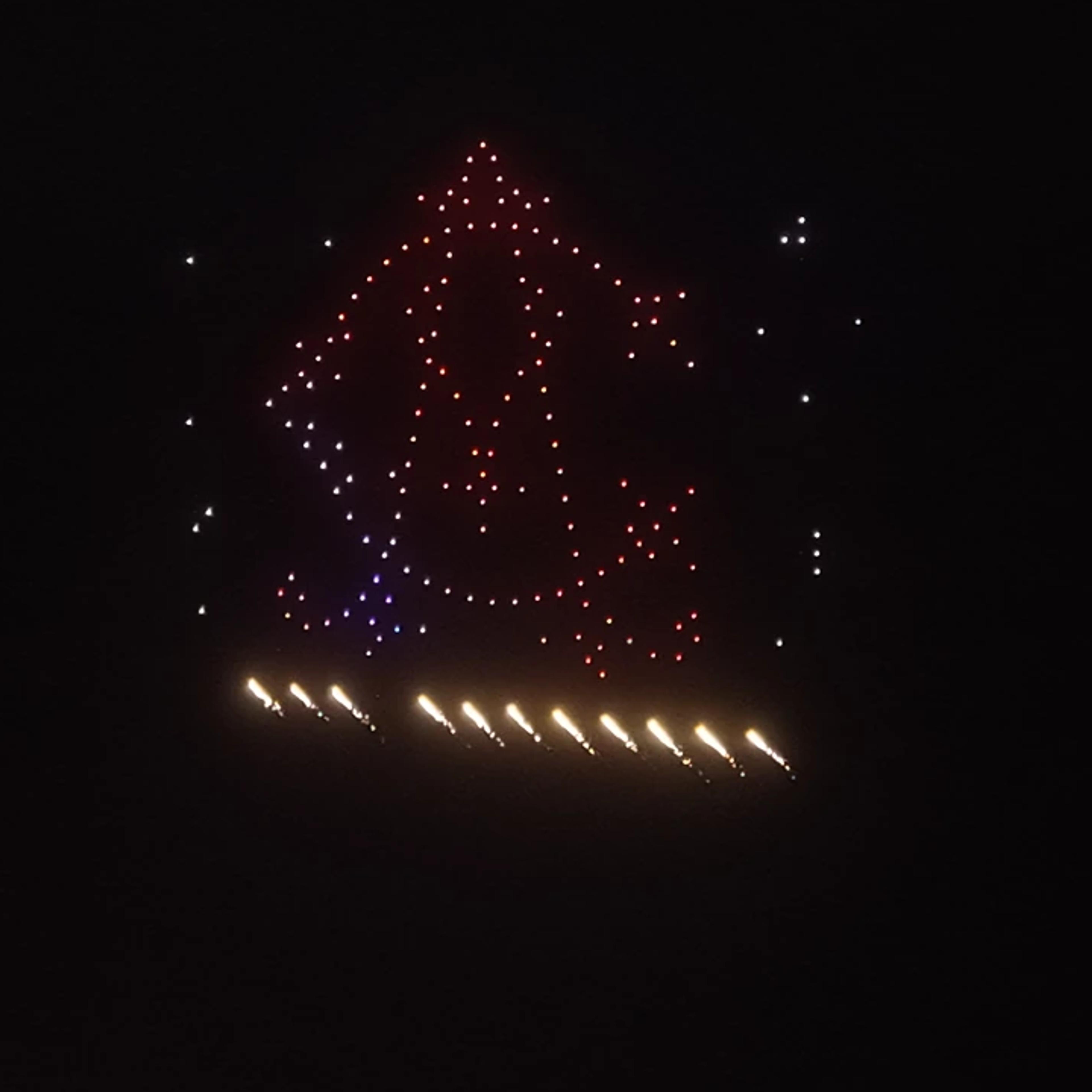 Bell-shaped drone formation with aerial pyrotechnic effects at Christina and Andrew’s wedding, iDrone’s second pyrodrones show in Bali.