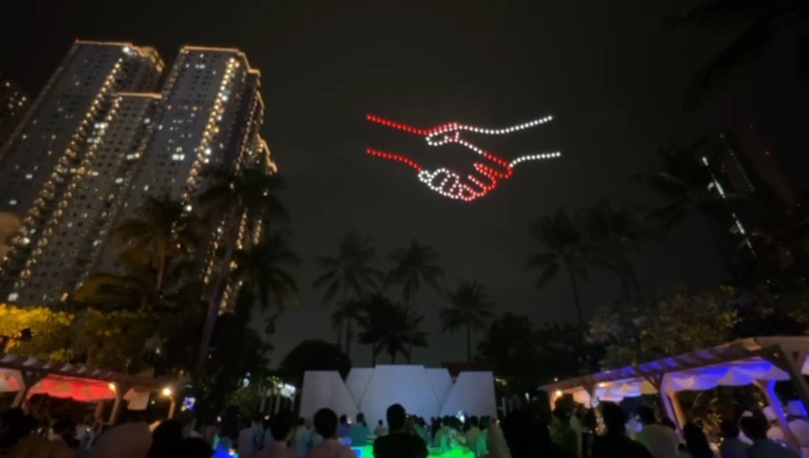 Drone light show depicts two hands reaching and connecting in red and white symbolising nationwide distributor partnership, Pertamina Lubricant NDS 2026 Jakarta