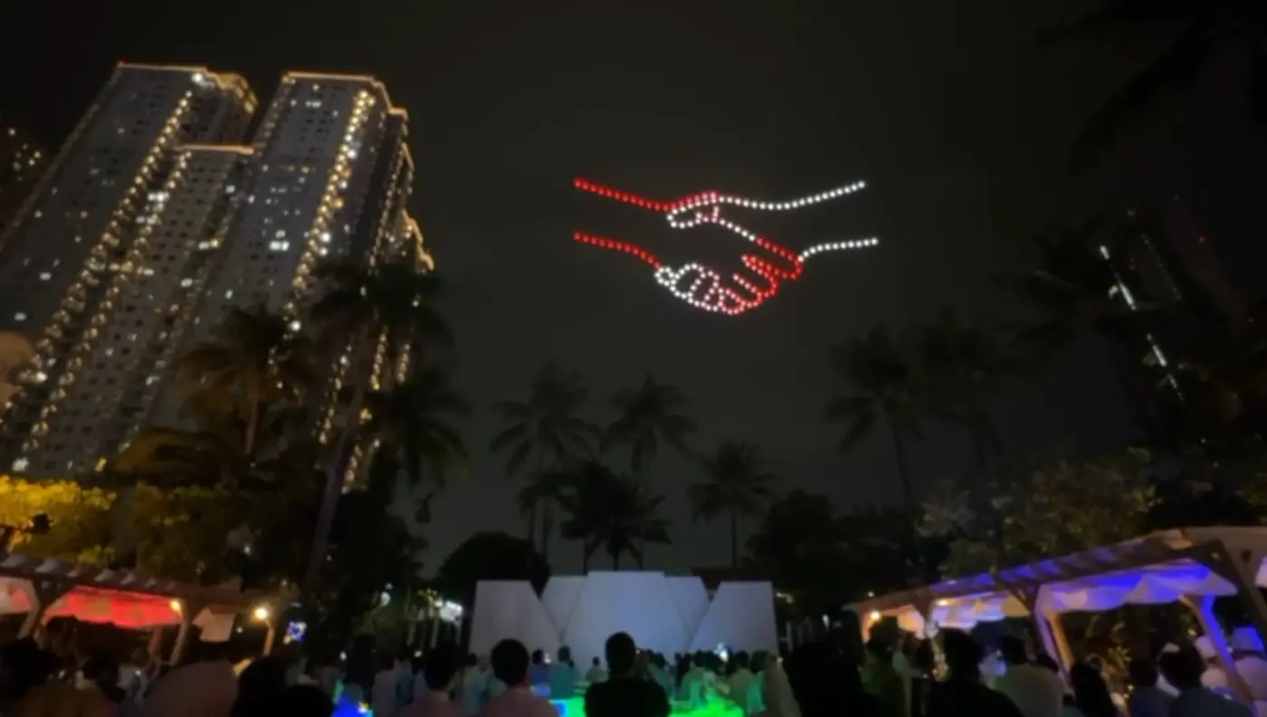 Drone light show depicts two hands reaching and connecting in red and white symbolising nationwide distributor partnership, Pertamina Lubricant NDS 2026 Jakarta