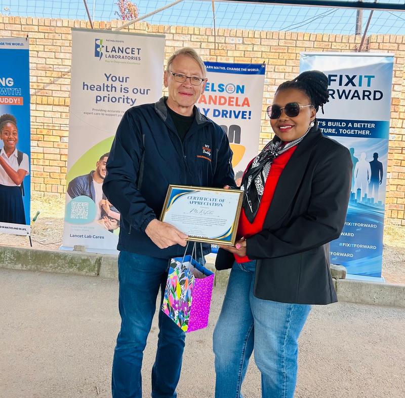 Ms Palesa Rafube recieveing are gift from Paul