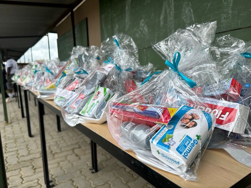 A line of ready-to-distribute dignity packs containing sanitary products, soap, toothpaste and other essential toiletries
